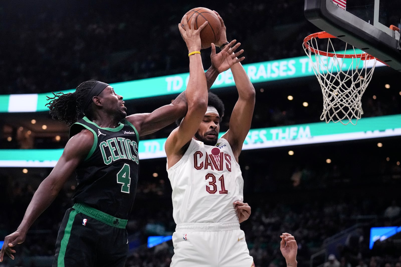 Boston Celtics guard Jrue Holiday (4) battles for a rebound against Cleveland Cavaliers center Jarrett Allen (31) during the first half of an Emirates NBA Cup basketball game, Tuesday, Nov. 19, 2024, in Boston. (AP Photo/Charles Krupa)