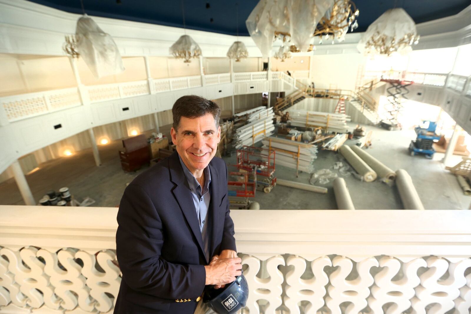 The two-story Eichelberger Pavilion can seat up to 700 people for weddings or corporate events. Brass castings of historic NCR cash registers inspired the patterns in the wall paper, carpet and the railings around the mezzanine. The pavilion is part of the new Winsupply Center of Leadership at Carillon Historical Park. Pictured is Brady Kress, president and CEO of Dayton History. LISA POWELL / STAFF