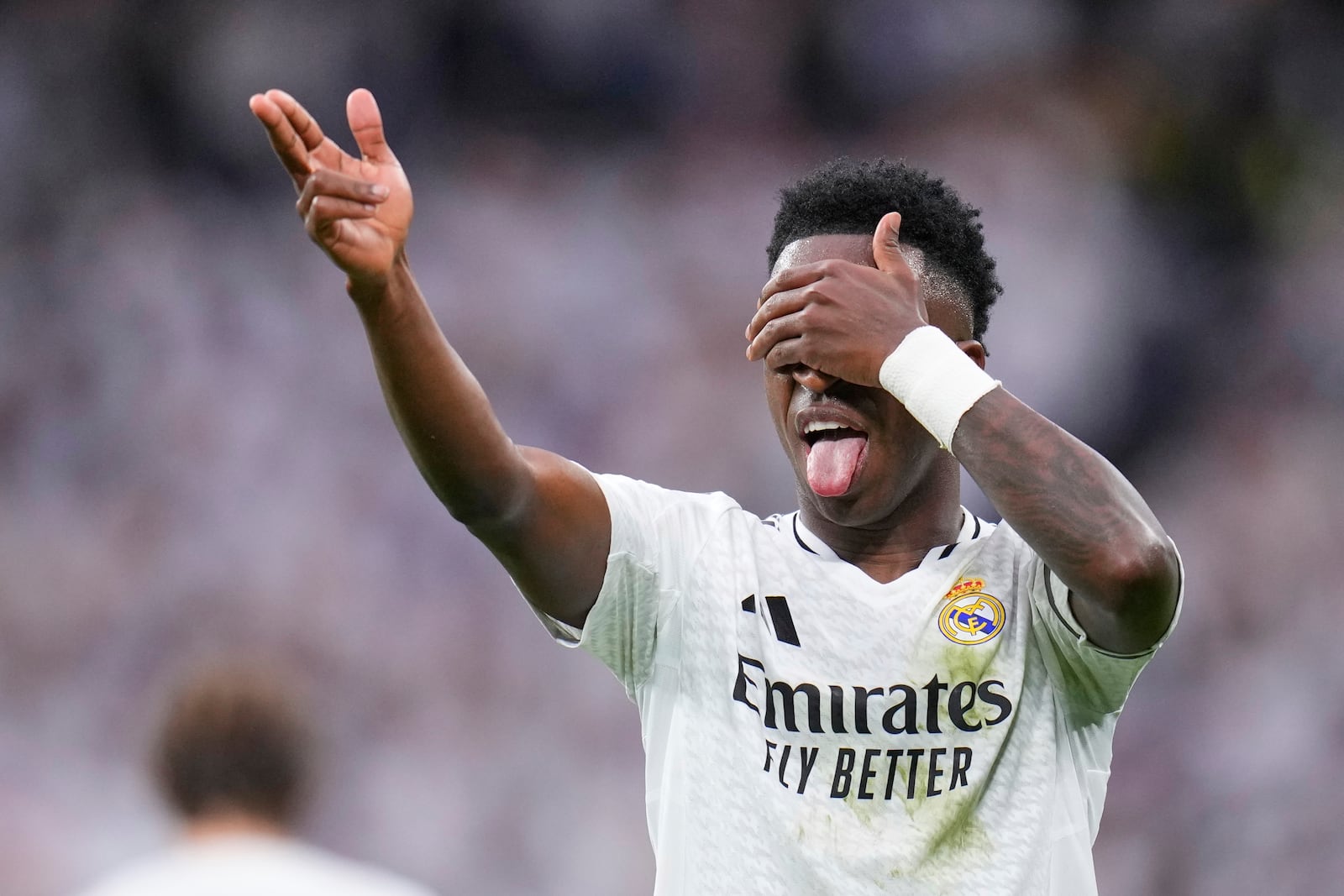 Real Madrid's Vinicius Junior celebrates after scoring his side's second goal during the Spanish La Liga soccer match between Real Madrid and Rayo Vallecano at the Santiago Bernabeu stadium in Madrid, Spain, Sunday, March 9, 2025. (AP Photo/Manu Fernandez)