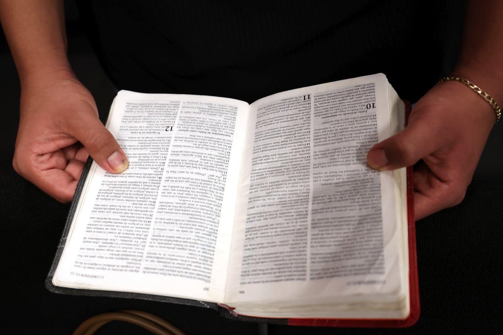 A worshipper holds a bible during services at Casa de Adoracion, Sunday, Oct. 27, 2024 in Phoenix. (AP Photo/Chris Coduto)