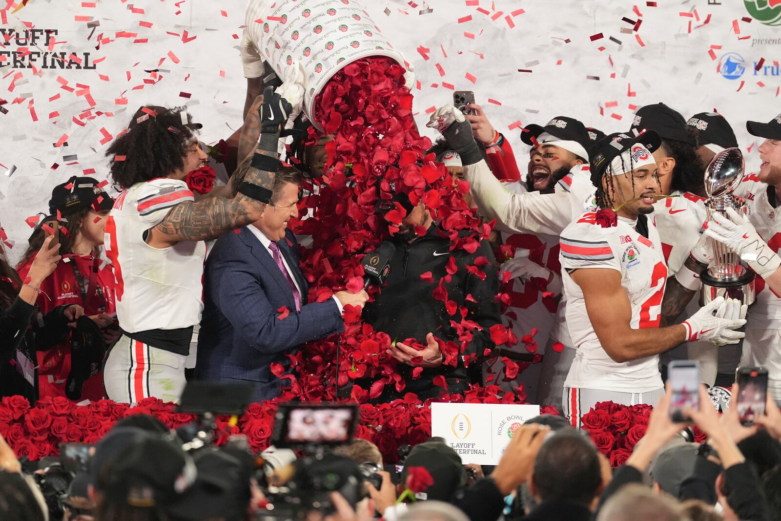 Ohio State players dunk rose petals on head coach Ryan Day after winning the quarterfinals of the Rose Bowl College Football Playoff against Oregon, Wednesday, Jan. 1, 2025, in Pasadena, Calif. (AP Photo/Mark J. Terrill)