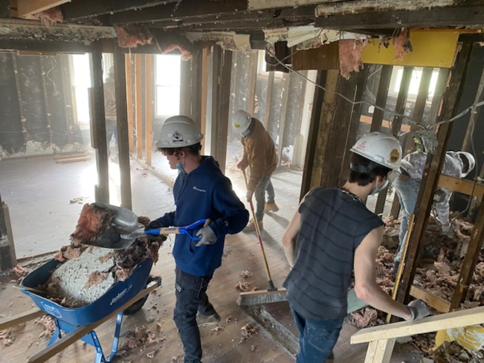 Habitat for Humanity and Cliff Park School worked together on a Springfield house, which is now complete for keys to  be handed over to the new owner on Jan. 13. Work on the South Bell Street house started in 2021. Cliff Park students are shown doing demolition work early in the project. CONTRIBUTED