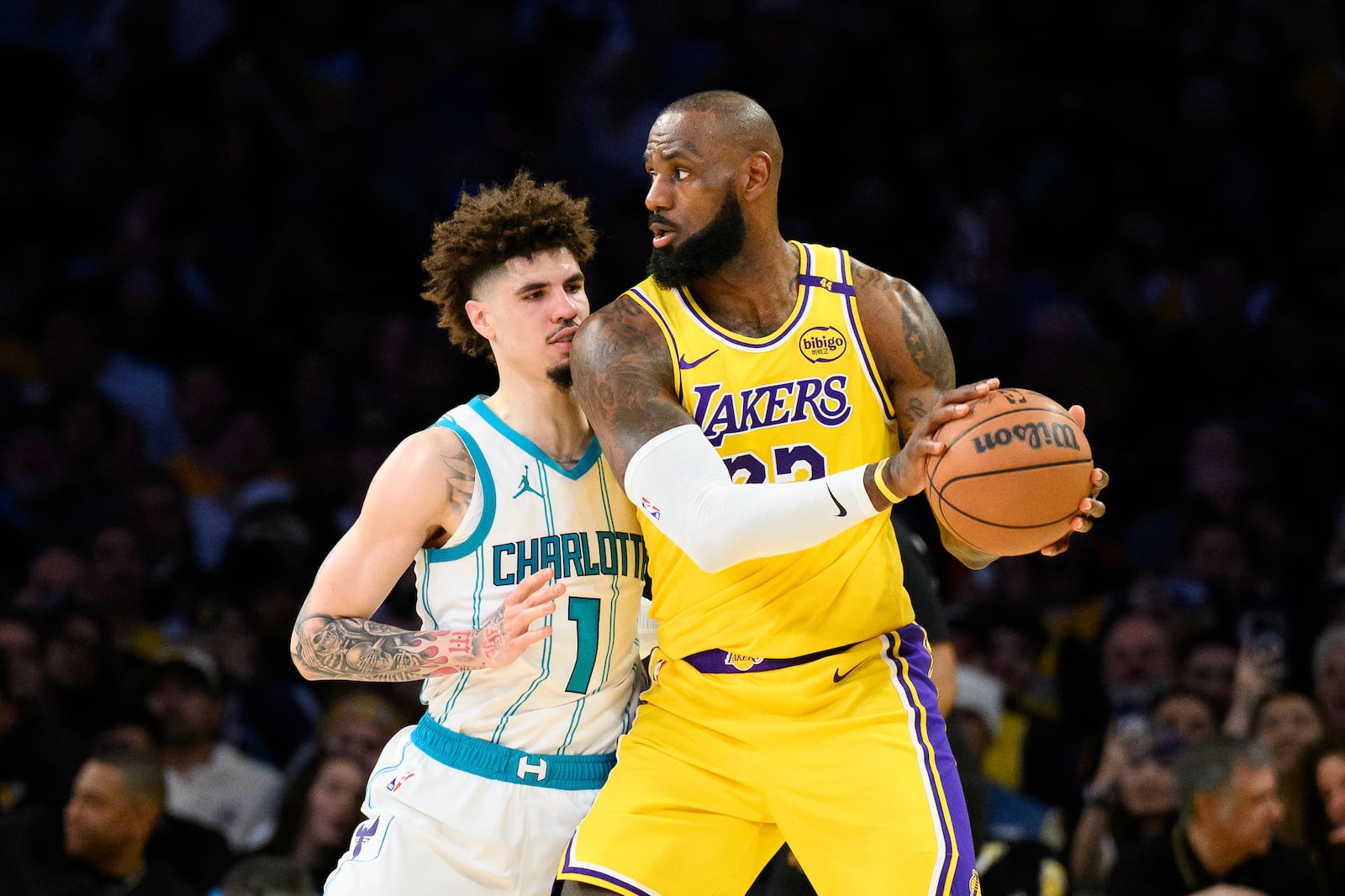 Los Angeles Lakers forward LeBron James looks to drive the ball against Charlotte Hornets guard LaMelo Ball (1) during the first half of an NBA basketball game Wednesday, Feb. 19, 2025, in Los Angeles. (AP Photo/William Liang)