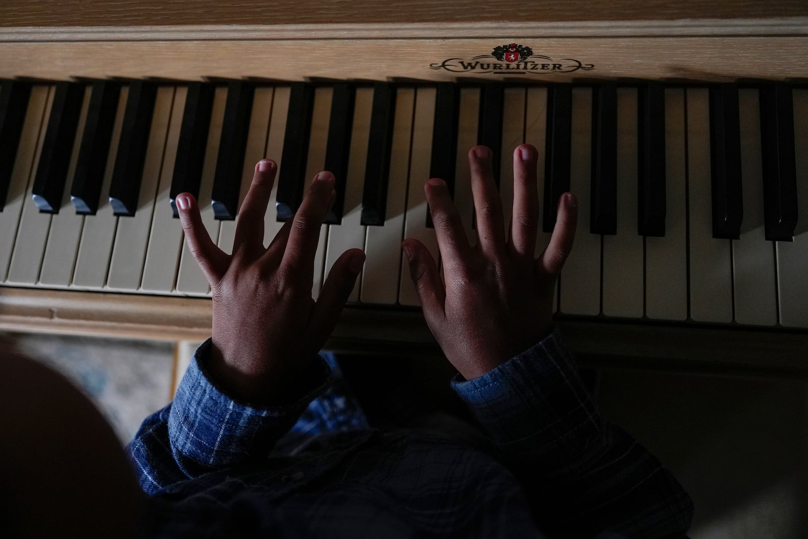 Lucas Young, 8, plays the piano during homeschooling on Tuesday, Nov. 12, 2024, in Sunbury, Ohio. (AP Photo/Carolyn Kaster)