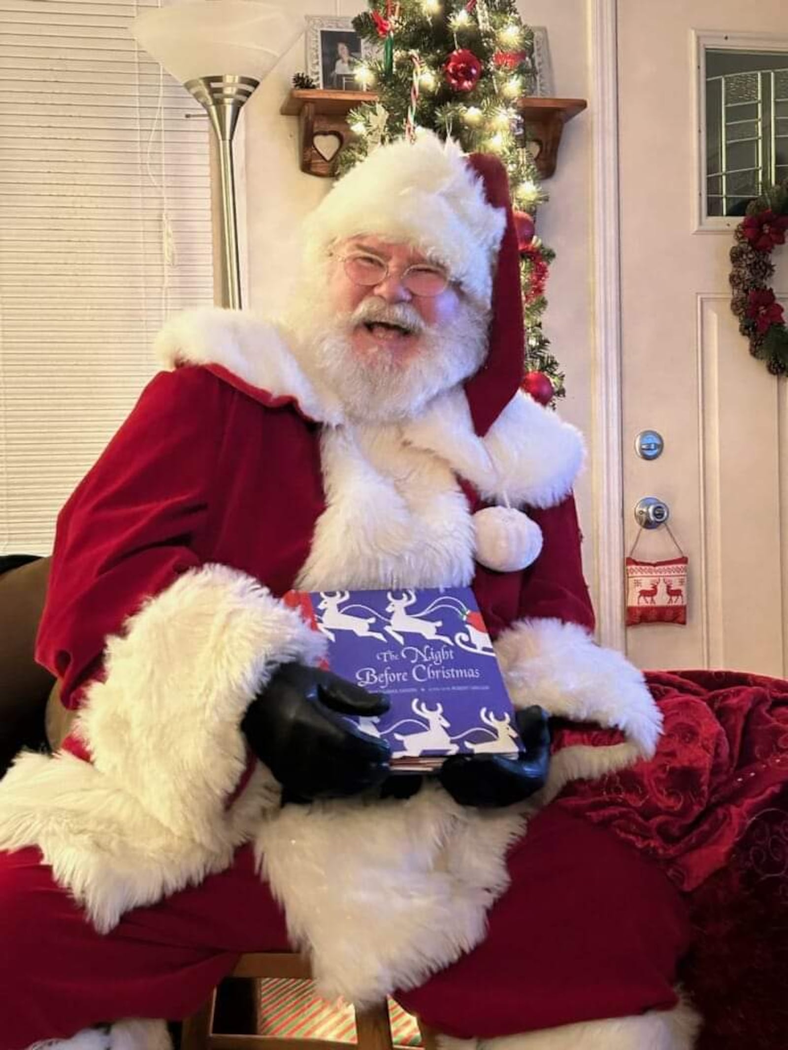 Santa actor Jeff Babb, 63, visits homes and enjoys reading a special "The Night Before Christmas" pop-up book. CONTRIBUTED