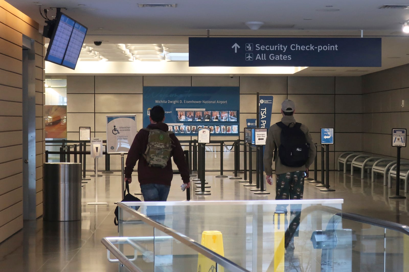 Passengers head for the gates for departing flights at Eisenhower National Airport in Wichita, Kan., the starting point for a passenger airliner involved in a deadly collision with an Army helicopter in Washington the day prior, Thursday, Jan. 30, 2025. (AP Photo/John Hanna)