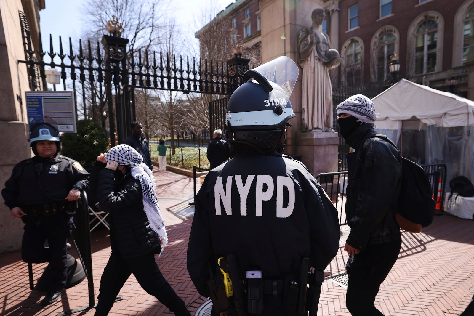 Police guard the entrance to Columbia University as protesters rally in support of detained Palestinian activist Mahmoud Khalil, Friday, March 14, 2025, in New York. (AP Photo/Jason DeCrow)