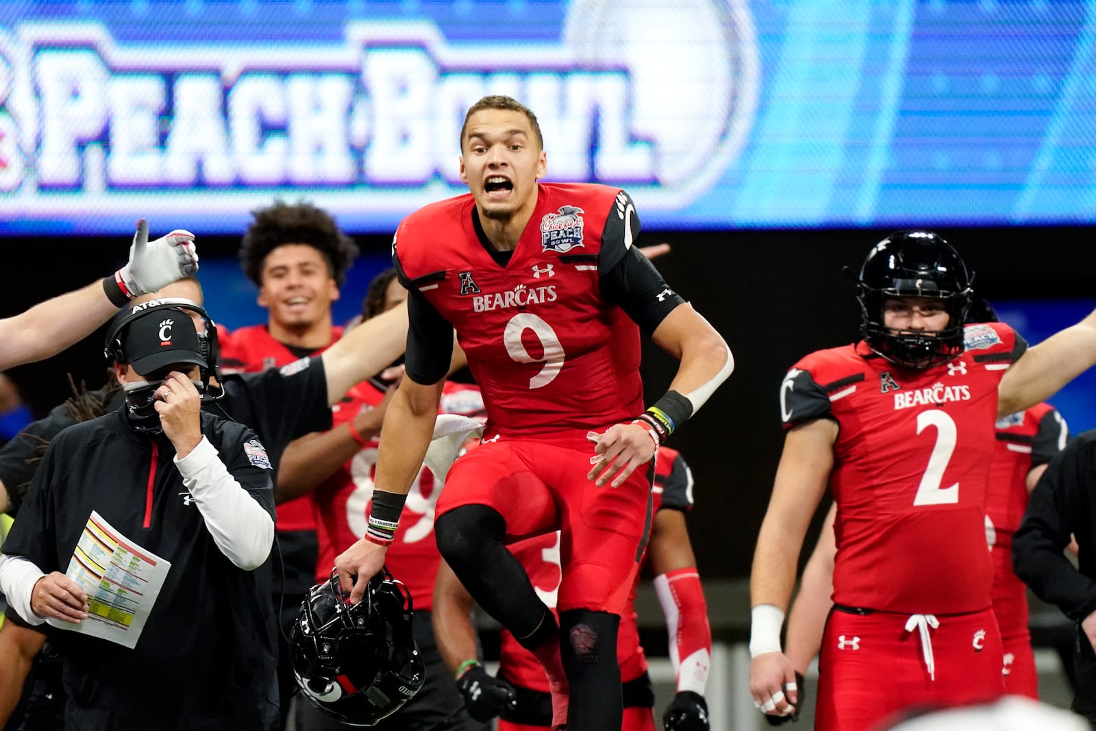 Cincinnati quarterback Desmond Ridder (9) reacts to a Georgia fumble during the second half of the Peach Bowl NCAA college football game, Friday, Jan. 1, 2021, in Atlanta. (AP Photo/Brynn Anderson)