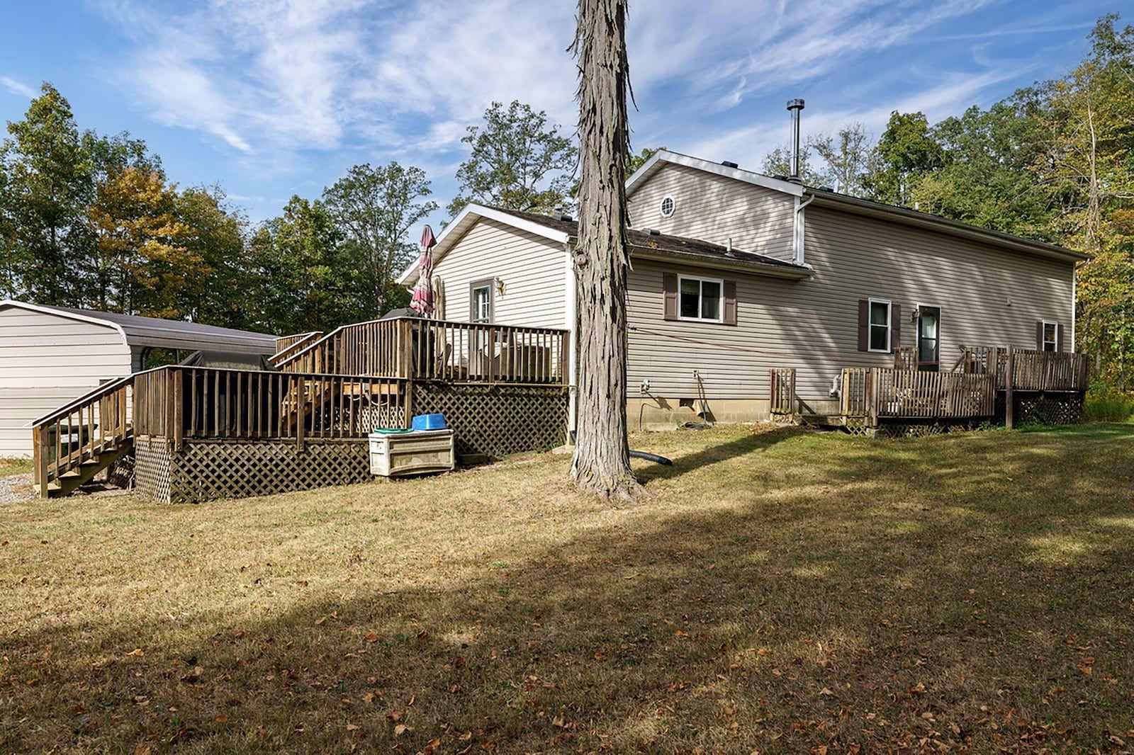 The wood two level deck is on the side of the home. The rear also has a smaller wood deck.