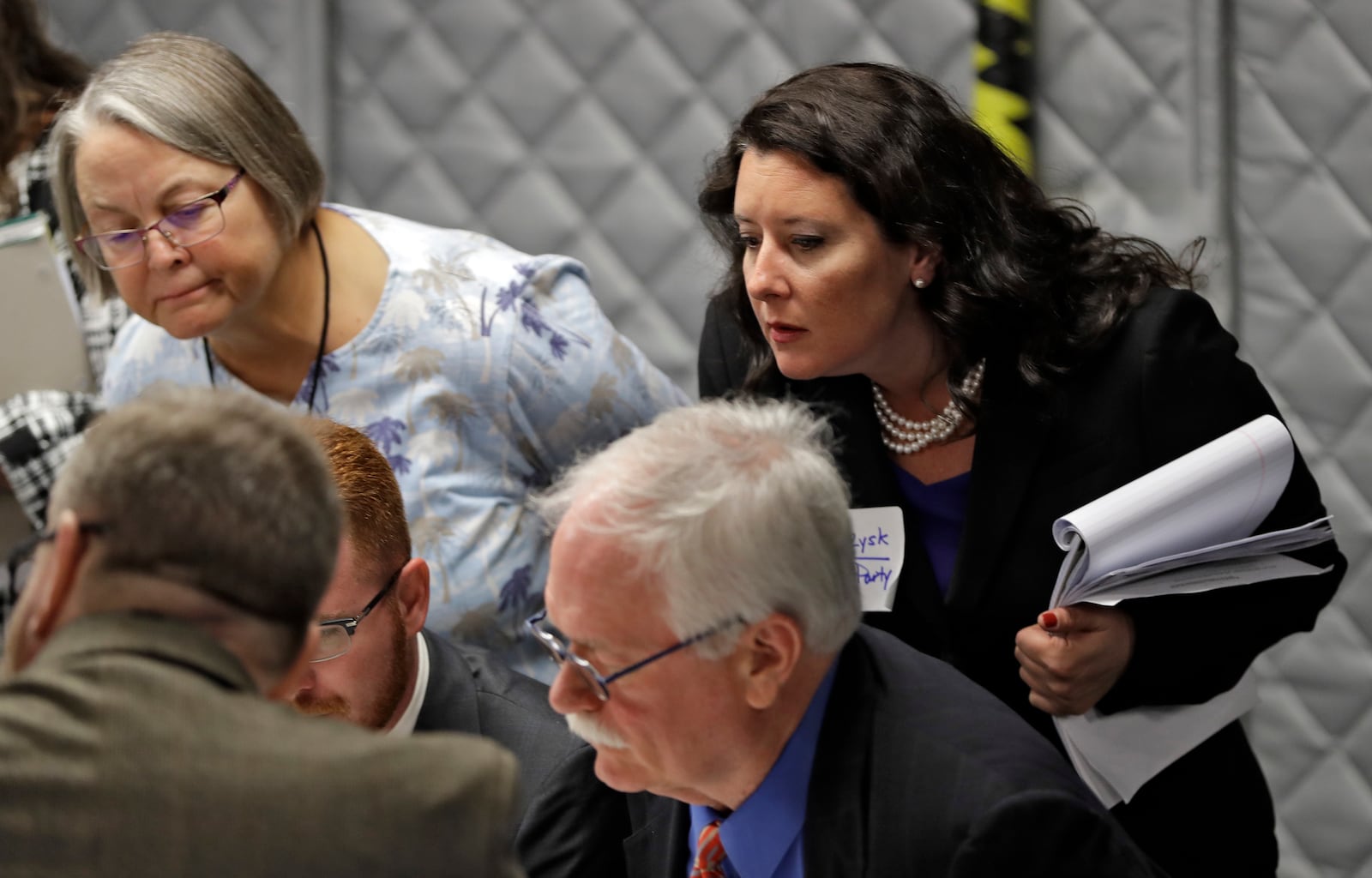 FILE - Democratic party observer Rachel May Zysk, right, looks on a volunteers check under and over votes during an elections manual recount for three undecided races Friday, Nov. 16, 2018, in Tampa, Fla. (AP Photo/Chris O'Meara, File)