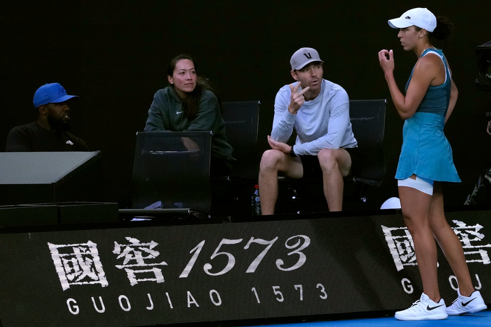 Madison Keys, right, of the U.S. talks with her coaches during her match against Aryna Sabalenka of Belarus during the women's singles final at the Australian Open tennis championship in Melbourne, Australia, Saturday, Jan. 25, 2025. (AP Photo/Ng Han Guan)