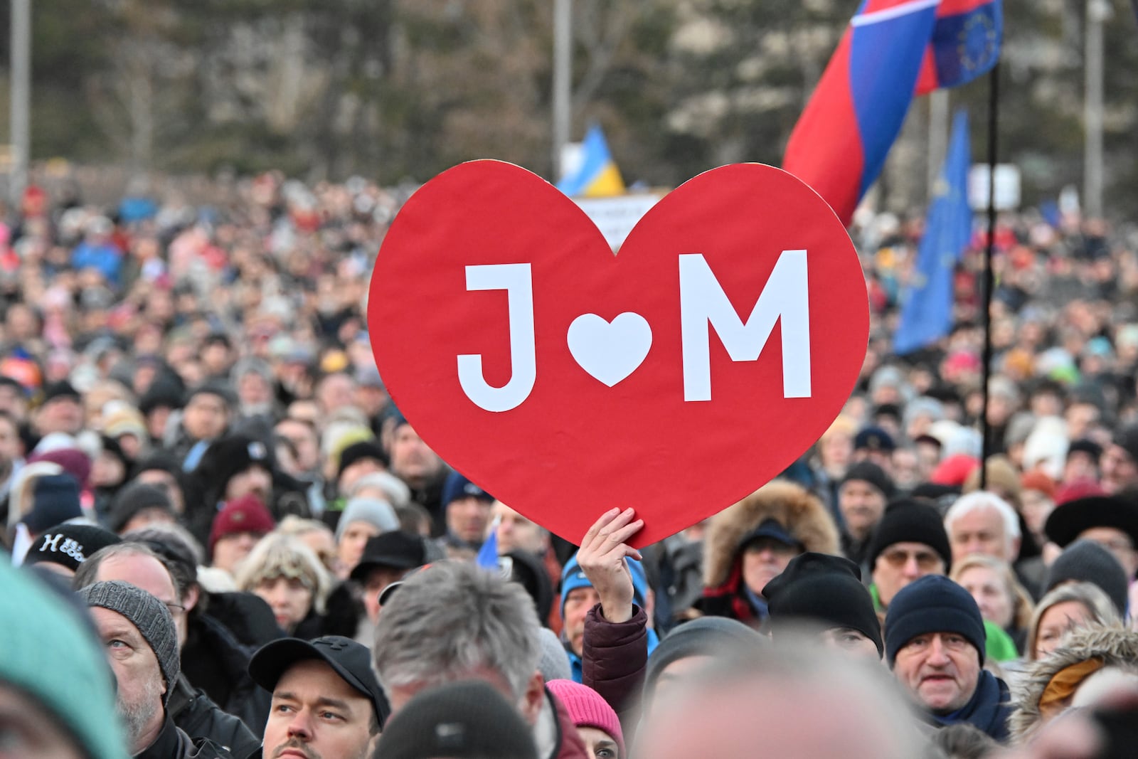 People gather in Bratislava, Slovakia on Friday Feb. 21, 2025, to mark the seventh anniversary of the slayings of an investigative journalist and his fiancee, Jan Kuciak and Martina Kusnirova. (Vaclav Salek/CTK via AP)