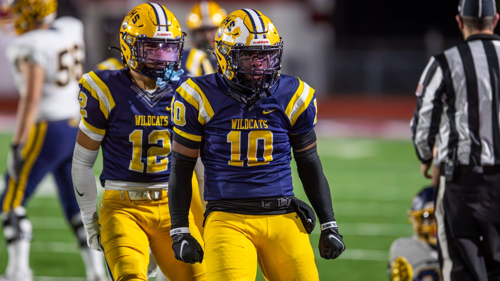 Springfield's Kyron Dolby (10) and Quenta Wafer celebrate a defensive play vs. Moeller in the state semifinals at Piqua on Nov. 24, 2023. Michael Cooper/CONTRIBUTED