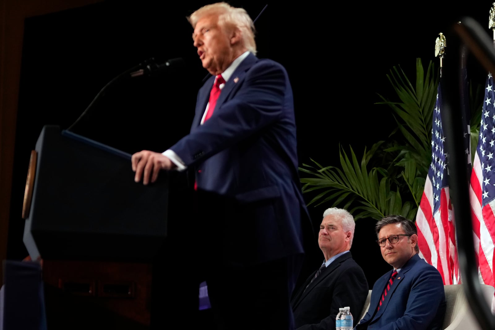 Rep. Tom Emmer, R-Minn., and House Speaker Mike Johnson of La., listen as President Donald Trump speaks at the 2025 House Republican Members Conference dinner at Trump National Doral Miami in Doral, Fla., Monday, Jan. 27, 2025. (AP Photo/Mark Schiefelbein)