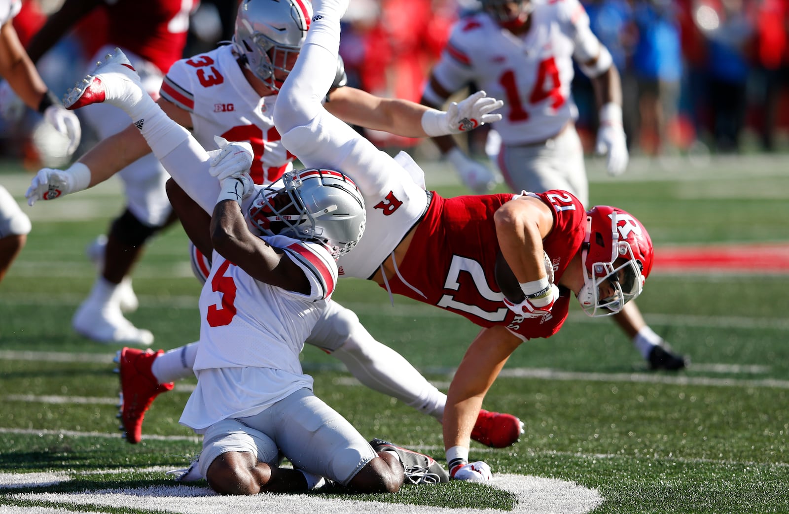 Rutgers quarterback Johnny Langan (21) is tackled by Ohio State cornerback Marcus Williamson (5) during an NCAA football game, Saturday, Oct. 2, 2021, in Piscataway, N.J. (AP Photo/Noah K. Murray)