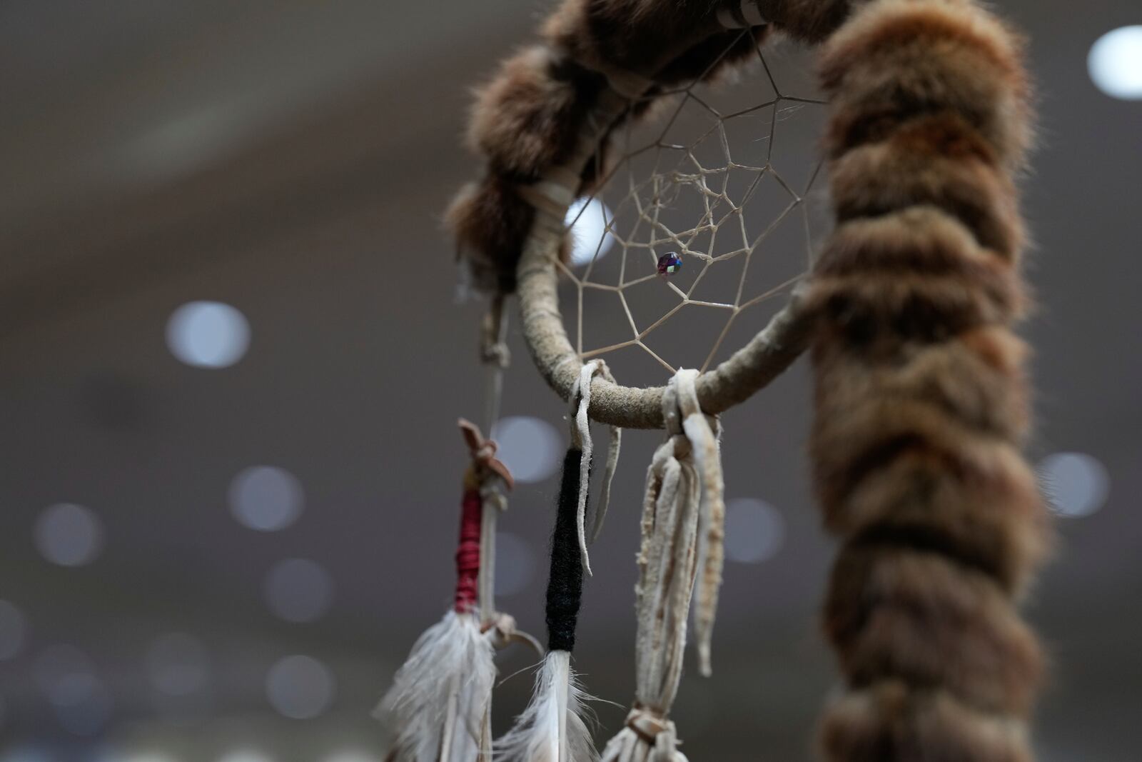 A dream catcher is seen on an eagle staff during a powwow at Chinook Winds Casino Resort, Saturday, Nov. 16, 2024, in Lincoln City, Ore. (AP Photo/Jenny Kane)