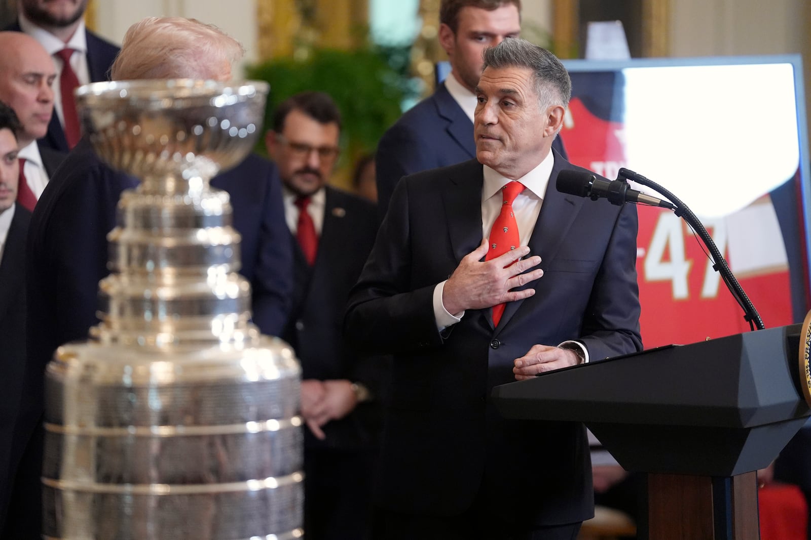 Vincent Viola, team owner of the 2024 NHL Stanley Cup champion Florida Panthers hockey team, speaks as President Donald Trump, obscured at left, listens during a ceremony to honor the team in the East Room of the White House, Monday, Feb. 3, 2025, in Washington. (AP Photo/Evan Vucci)