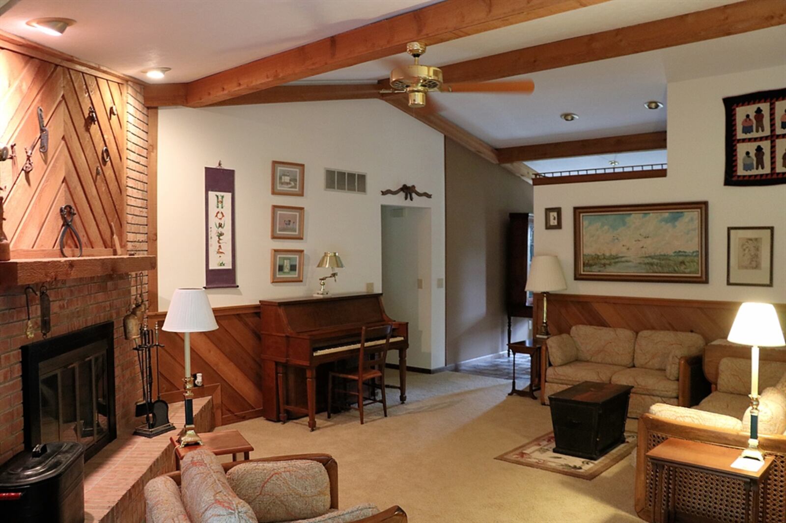 Tucked into a corner of the family room is an attractive brick fireplace.