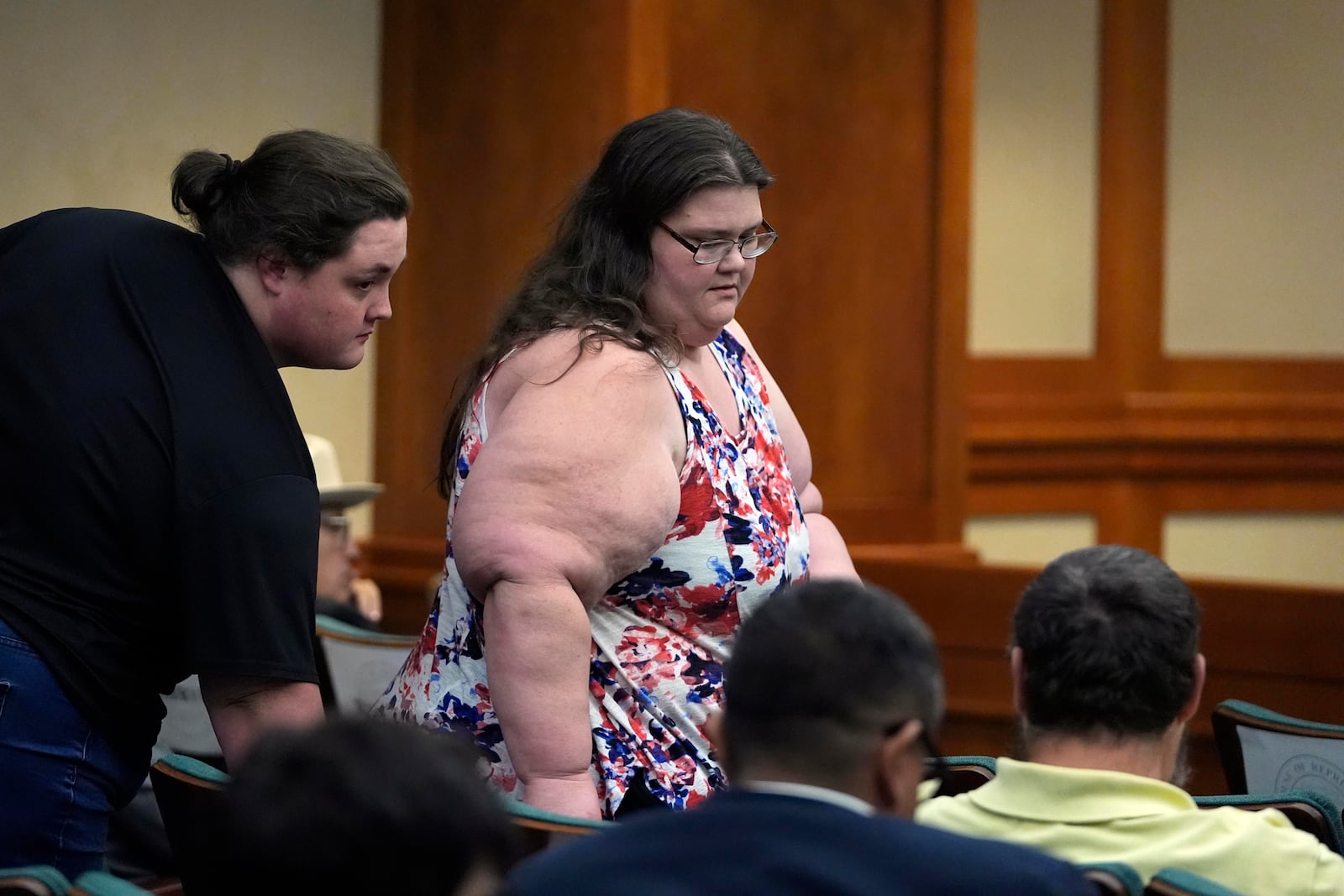 Jennifer Martin, center, and Thomas Roberson, in green shirt, right, attend a committee hearing on Robert Roberson's death row case, Monday, Oct. 21, 2024, in Austin, Texas. (AP Photo/Tony Gutierrez)