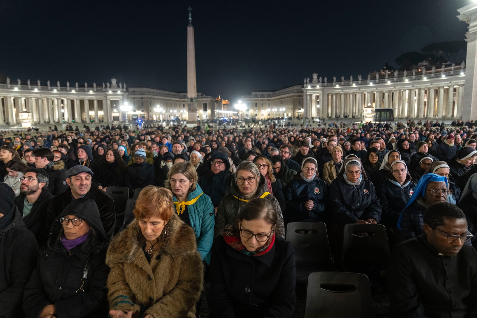 Catholic faithful attend a nightly rosary prayer for the health of Pope Francis in St. Peter's Square at the Vatican, Sunday, March 2, 2025. (AP Photo/Mosa'ab Elshamy)