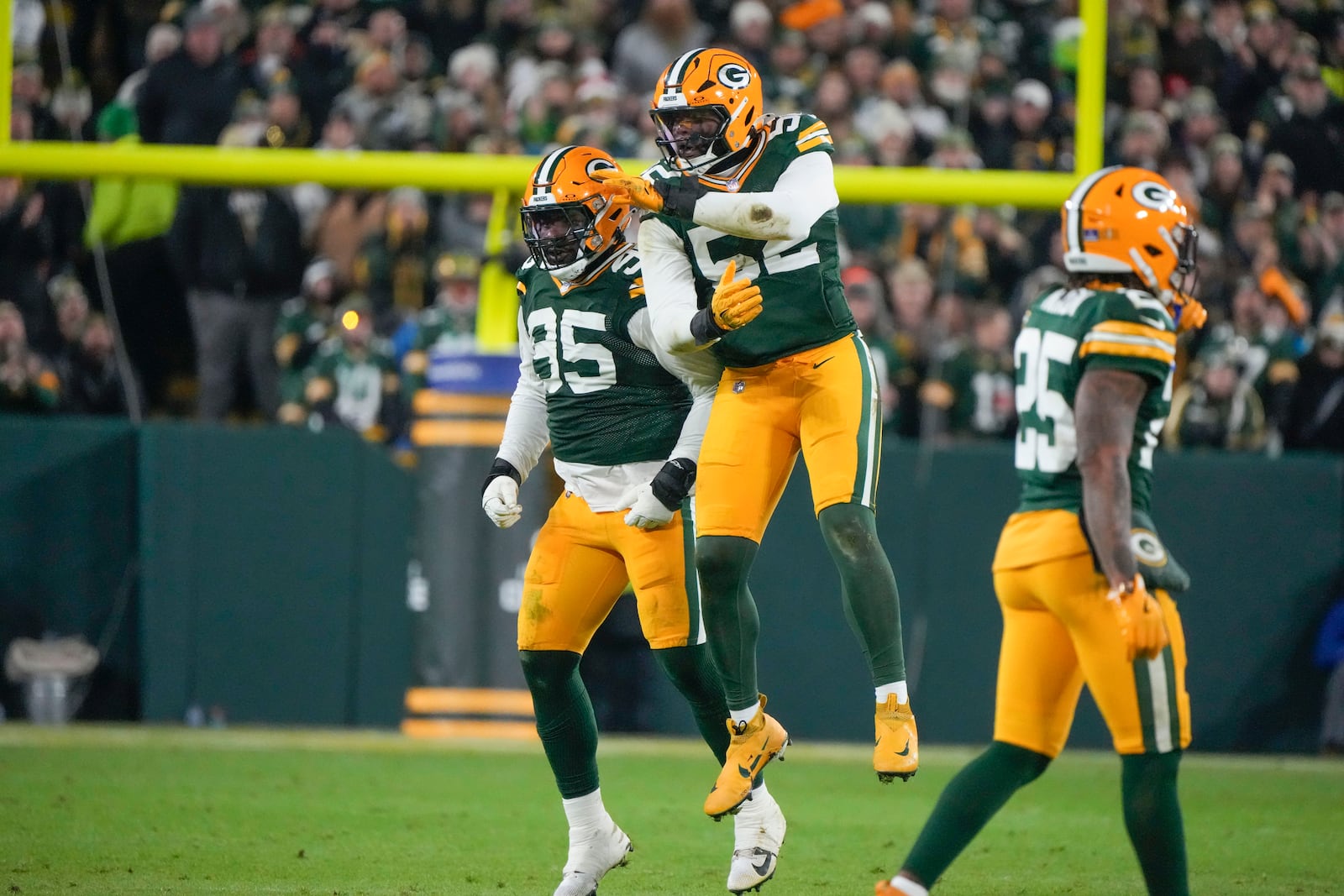 Green Bay Packers defensive tackle Devonte Wyatt (95) celebrates his sack with defensive end Rashan Gary (52) during the first half of an NFL football game, Monday, Dec. 23, 2024, in Green Bay, Wis. (AP Photo/Morry Gash)