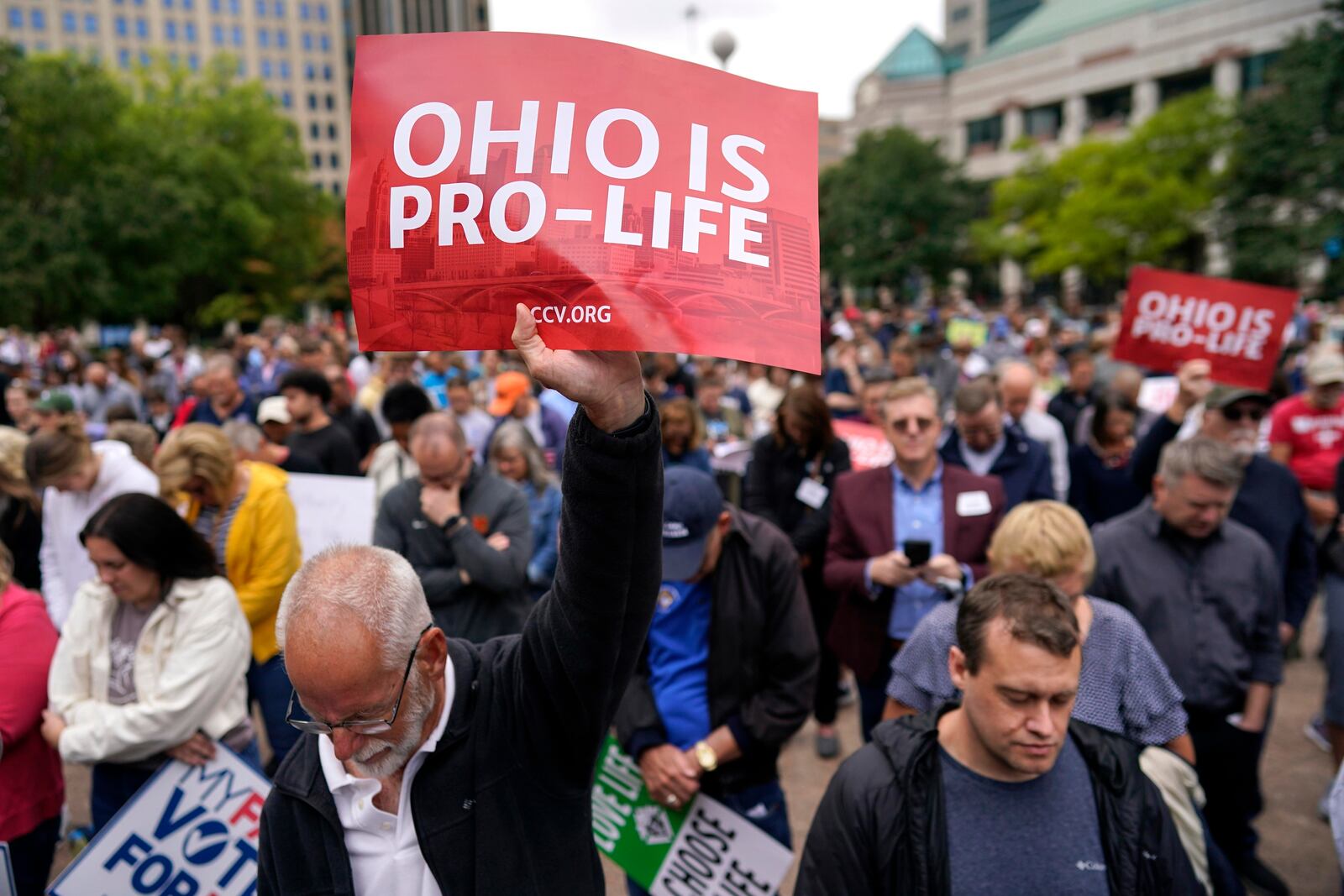 FILE - Paul Meacham holds high a sign that reads "Ohio is pro-life" as the crowd prays during the Ohio March for Life rally at the Ohio State House in Columbus, Ohio, Friday, Oct. 6, 2023. (AP Photo/Carolyn Kaster, File)