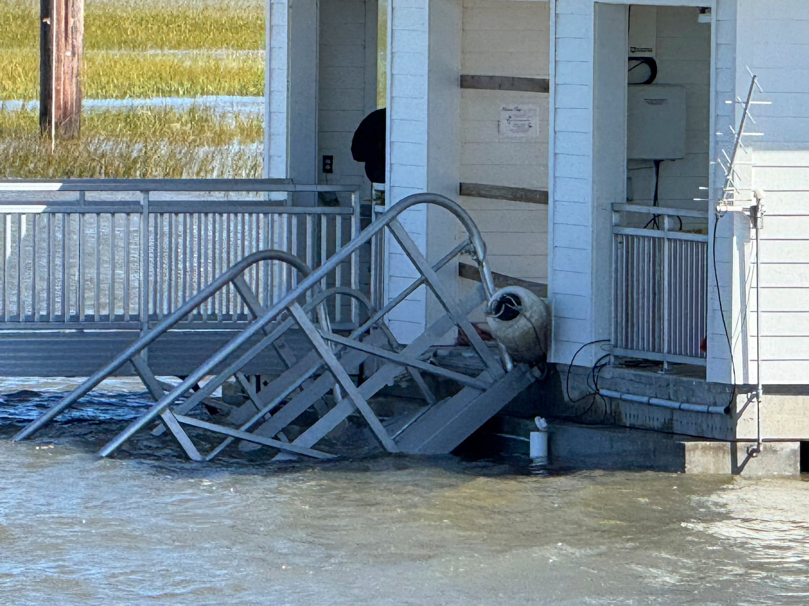 A portion of the gangway which collapsed Saturday afternoon remains visible on Sapelo Island in McIntosh county, Ga., Sunday, Oct. 20, 2024. (AP Photo/Lewis Levine)