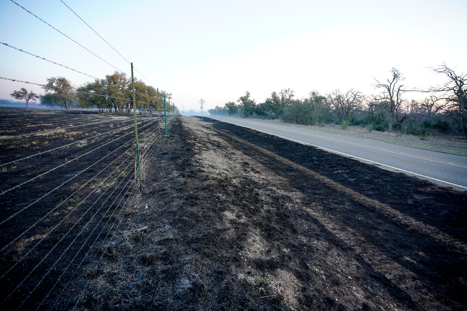 Gillespie County fields are charred along Ranch Road 1631 following the Crabapple Wildfire over the weekend, in Fredericksburg, Texas, Sunday, March 16, 2025. (Robin Jerstad/The San Antonio Express-News via AP)