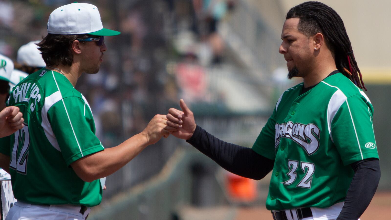 Reds starter Luis Castillo is greeted at the dugout by Dragons starter Connor Phillips after the second inning Sunday at DayAir Ballpark. Castillo pitched 2 1/3 innings in his first rehab start. Jeff Gilbert/CONTRIBUTED