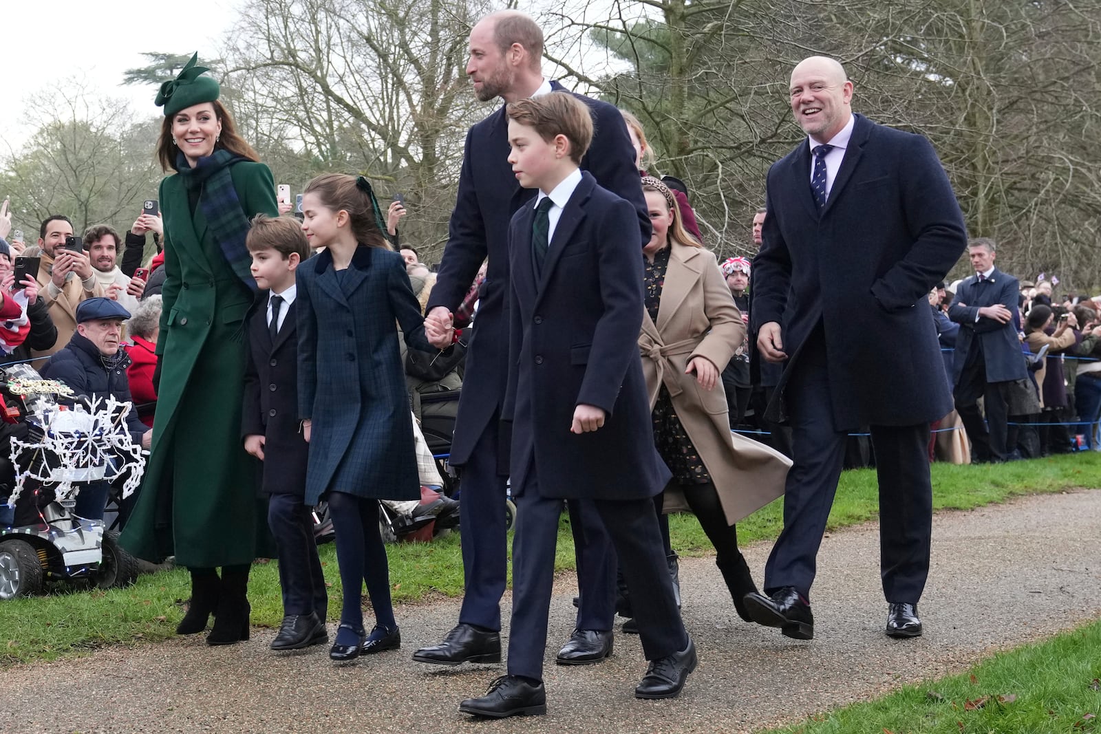 Kate, Princess of Wales, left, with Prince Louis, Princess Charlotte, Prince William and Prince George arrive for the Christmas day service at St Mary Magdalene Church in Sandringham in Norfolk, England, Wednesday, Dec. 25, 2024, at right, is Mike Tyndall husband of Zara Phillips. (AP Photo/Jon Super)