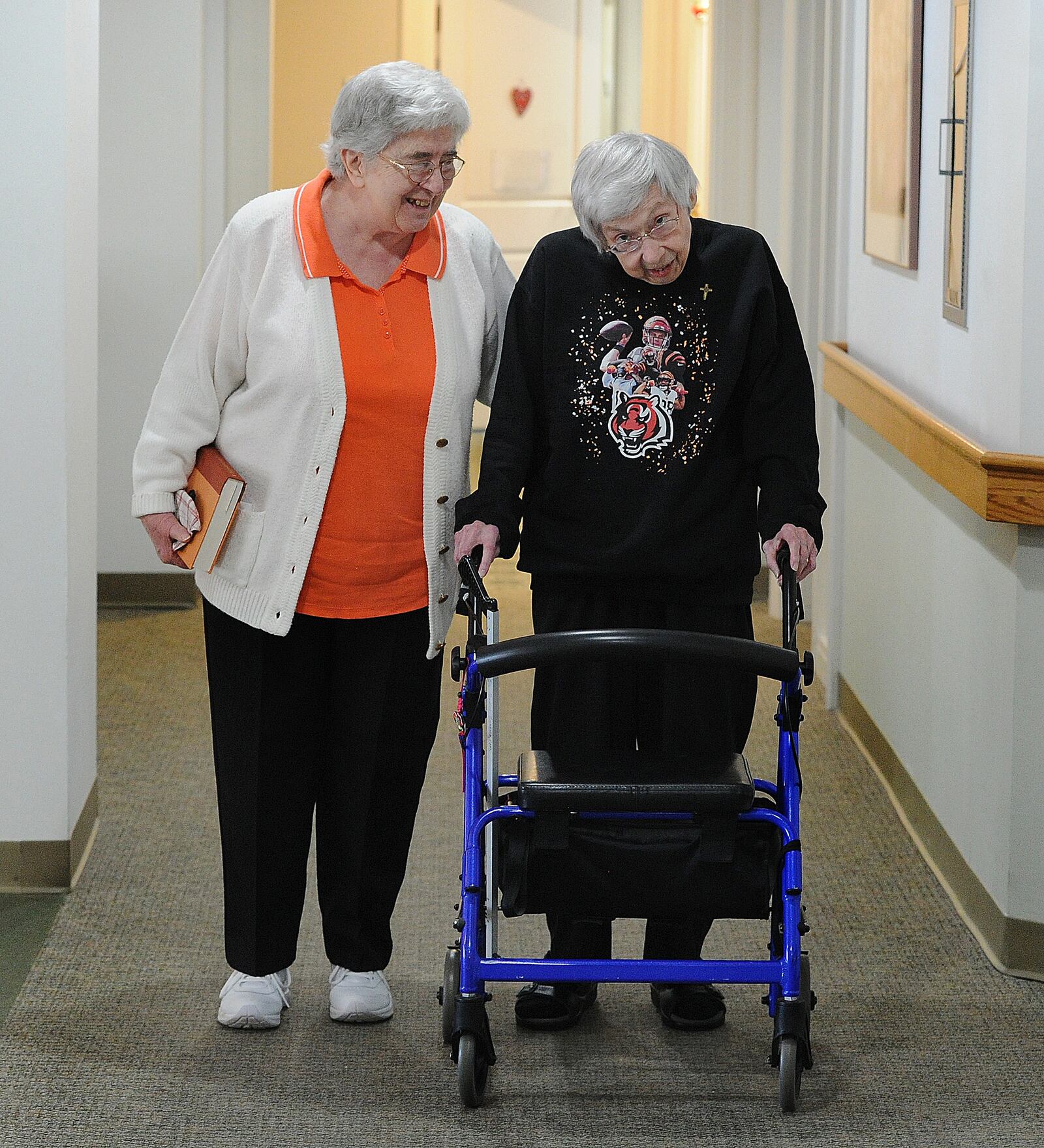 Sisters of Precious Blood of Dayton, Mary Ellen Lampe, left, and Margie Zureick discuss the Bengals and the Super Bowl Wednesday Feb. 9, 2022. Both are big Bengals fans and plan to watchCincinnati in the Super Bowl Sunday. MARSHALL GORBY\STAFF