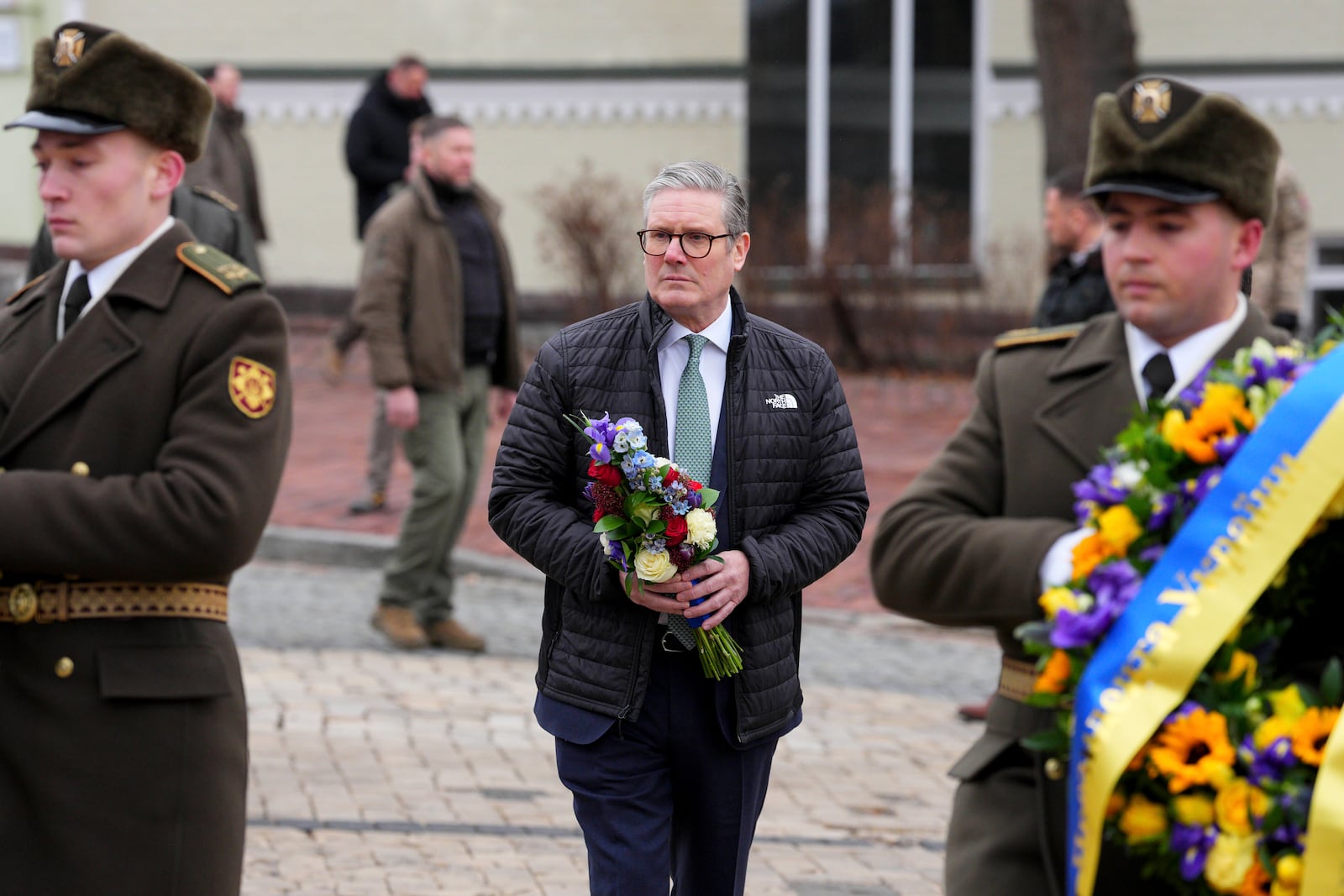 British Prime Minister Keir Starmer arrives with Ukrainian President Volodymyr Zelenskyy to lay wreaths at The Wall of Remembrance of the Fallen for Ukraine, in Kyiv, Ukraine Thursday, Jan. 16, 2025. (Carl Court/Pool Photo via AP)