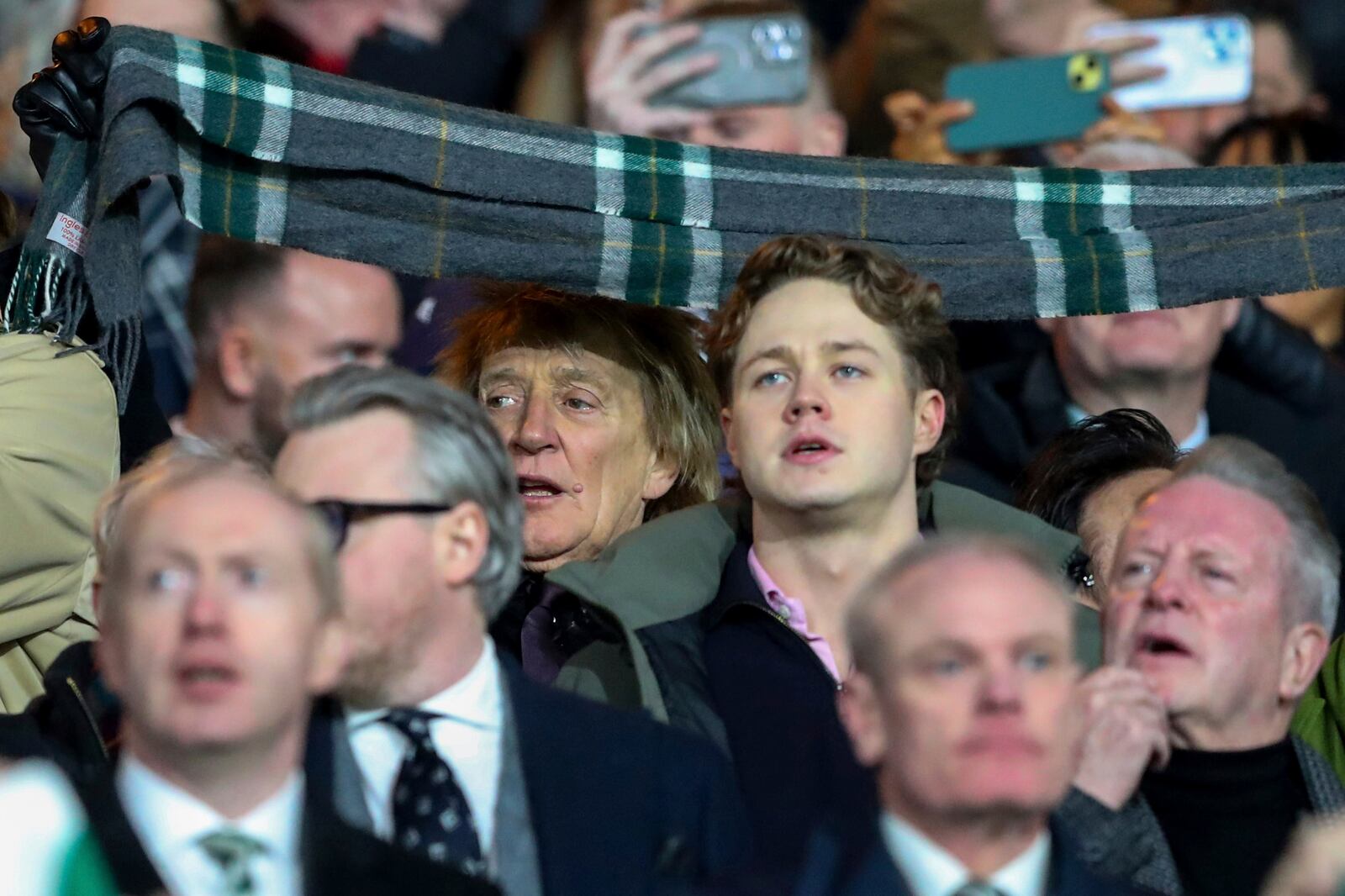 British pop icon Rod Stewart cheers the teams prior to the Champions League play off first leg soccer match between Celtic Glasgow and Bayern Munich at the Celtic Park Stadium in Glasgow, Scotland, Wednesday, Feb. 12, 2025. (AP Photo/Scott Heppell)