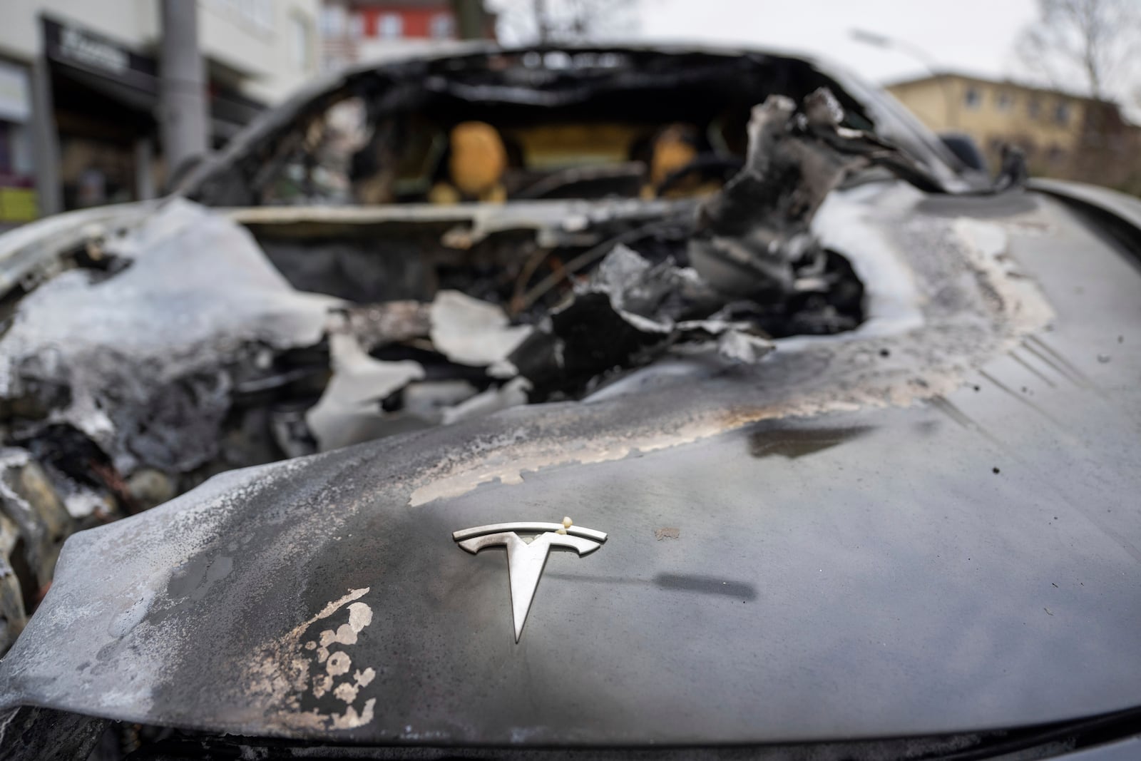 A burnt-out Tesla car stands in the Steglitz district of Berlin, Friday, March 14, 2025, as four Teslas are suspected to have been set on fire in Berlin last night. (Christophe Gateau/dpa via AP)