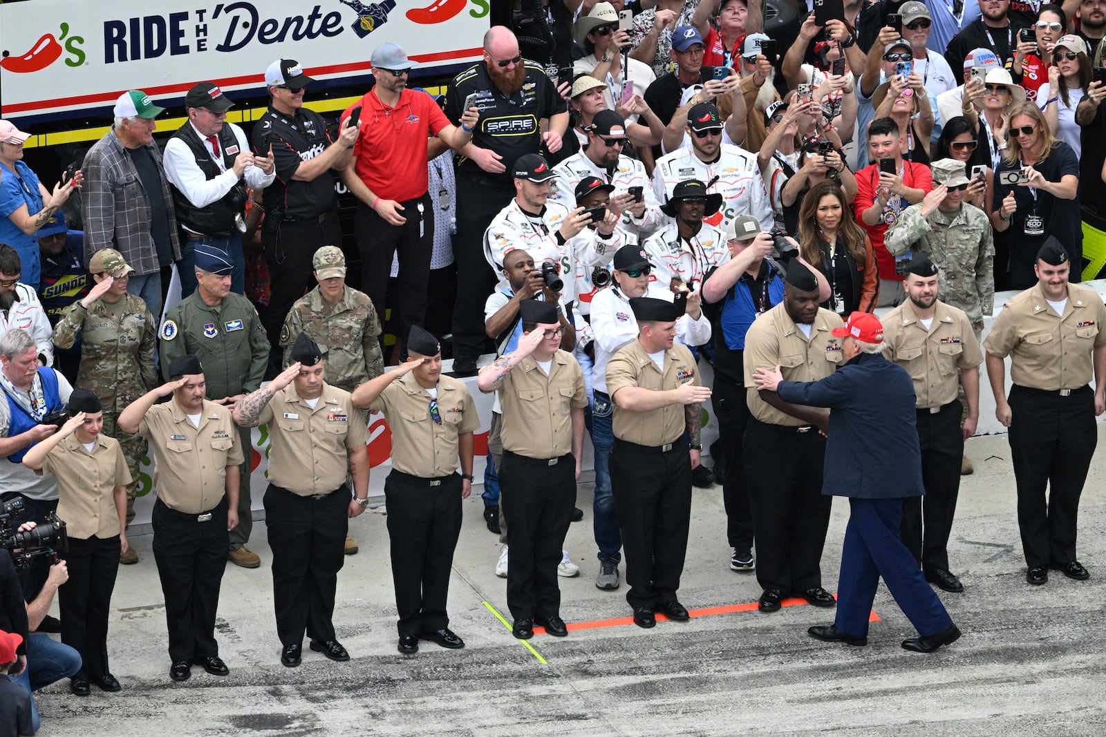 President Donald Trump greets service members on pit lane before the NASCAR Daytona 500 auto race at Daytona International Speedway, Sunday, Feb. 16, 2025, in Daytona Beach, Fla. (AP Photo/Phelan M. Ebenhack)