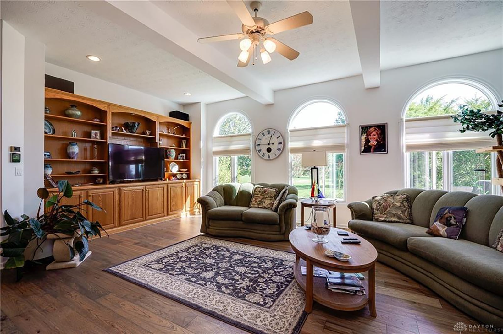 The living room has hardwood flooring, a gas fireplace and built in bookcases.