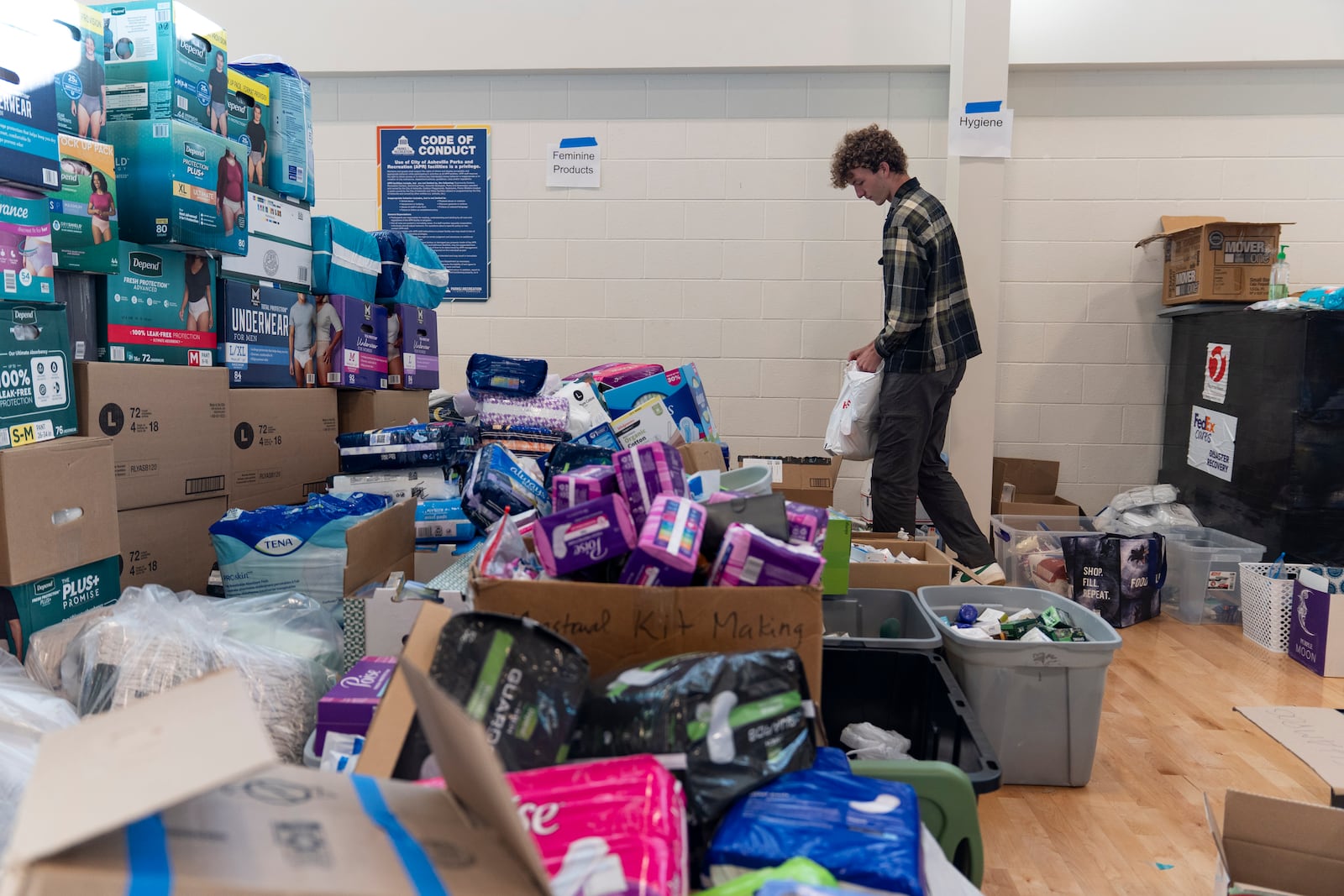 High school senior Nathan Flaherty packs hygiene kits for people in need of supplies as he volunteers in the aftermath of Hurricane Helene, Wednesday, Oct. 16, 2024, at the Dr. Wesley Grant Sr. Southside Community Center in Asheville, N.C. (AP Photo/Stephanie Scarbrough)