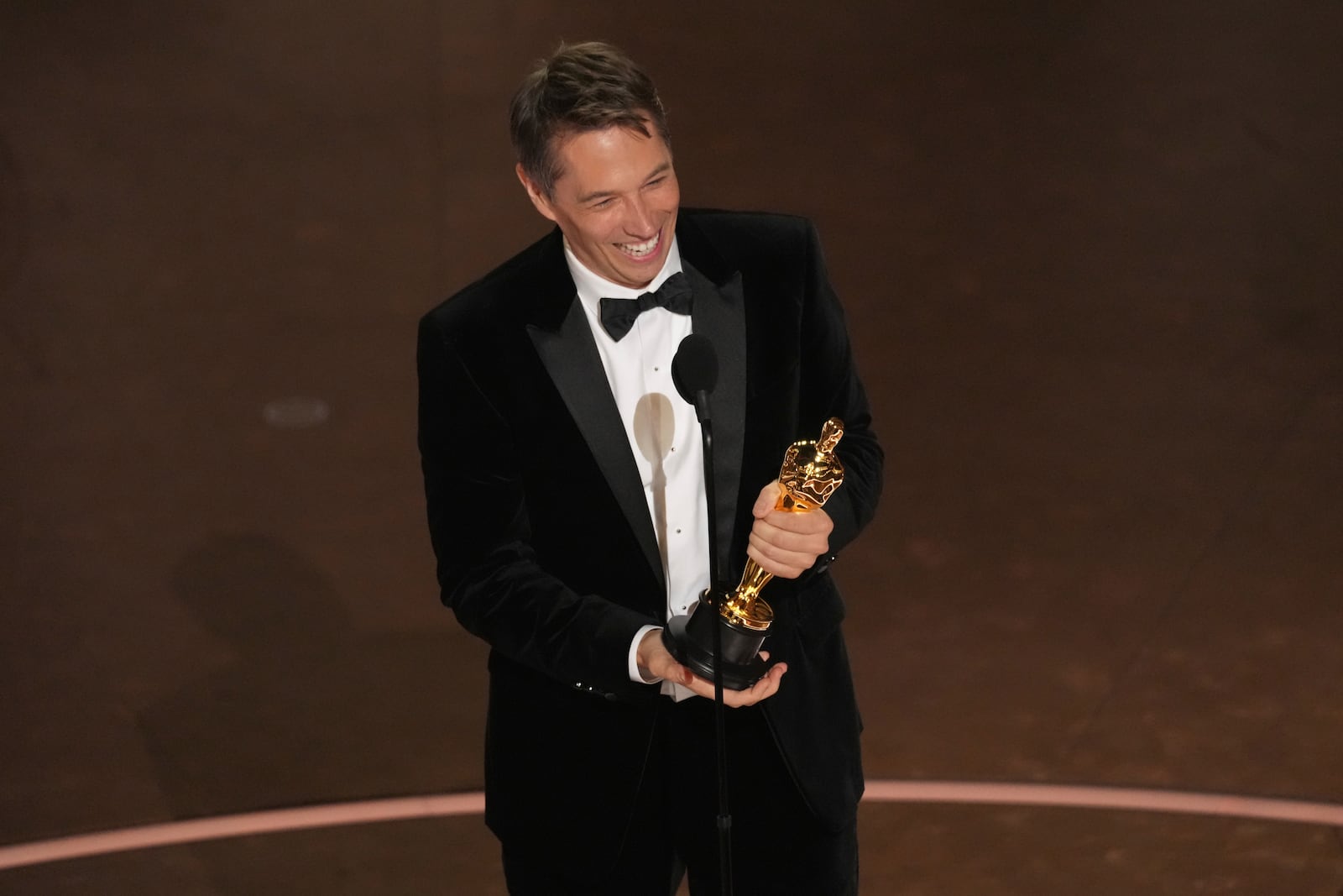 Sean Baker accepts the award for best director for "Anora during the Oscars on Sunday, March 2, 2025, at the Dolby Theatre in Los Angeles. (AP Photo/Chris Pizzello)