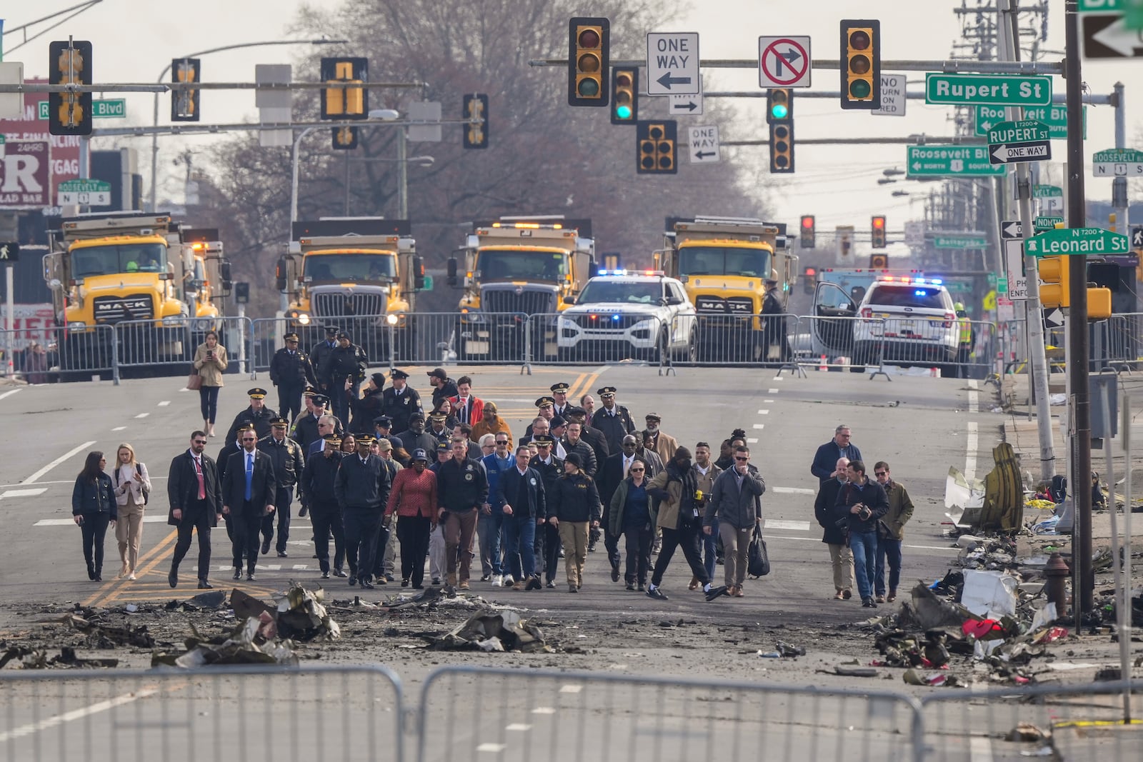 Pennsylvania Gov. Josh Shapiro, Philadelphia Mayor Cherelle Parker and other officials view the aftermath of a fatal small plane crashed in Philadelphia, Monday, Feb. 3, 2025. (AP Photo/Matt Rourke)