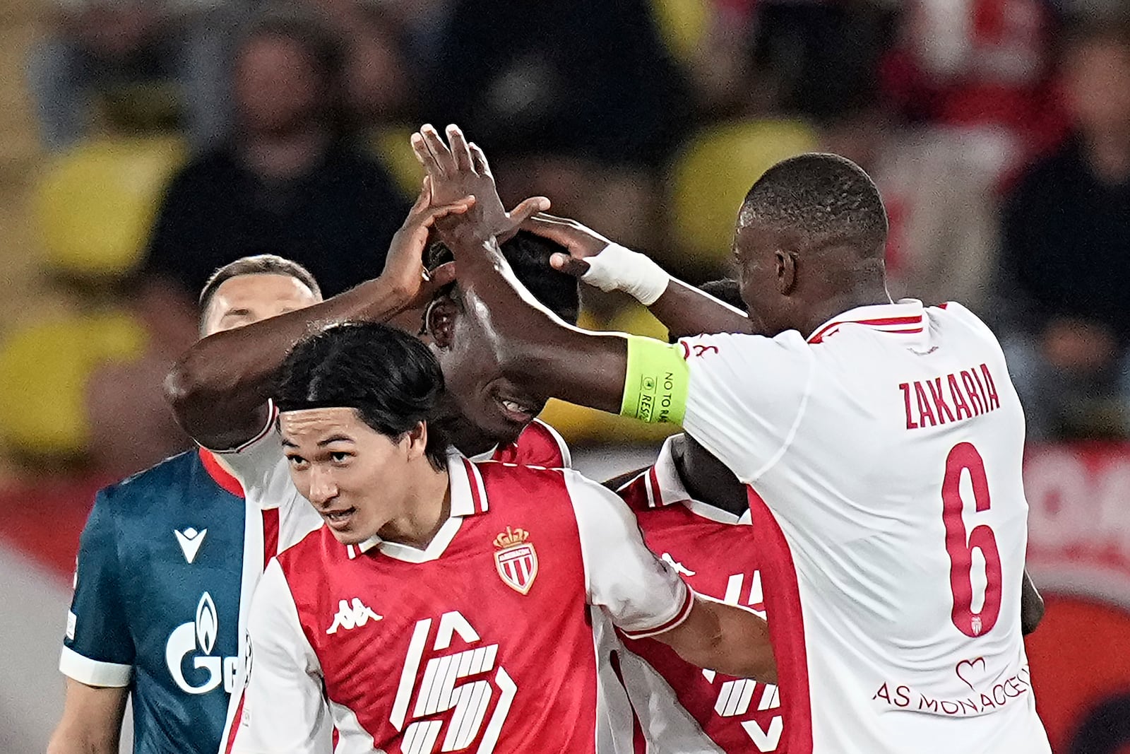 Monaco's Takumi Minamino, center, celebrates with his teammates after scoring the fourth goal during the Champions League opening phase soccer match between Monaco and Crvena Zvezda, Red Star Belgrade, at the Louis II stadium, in Monaco, Tuesday, Oct. 22, 2024. (AP Photo/Laurent Cipriani)