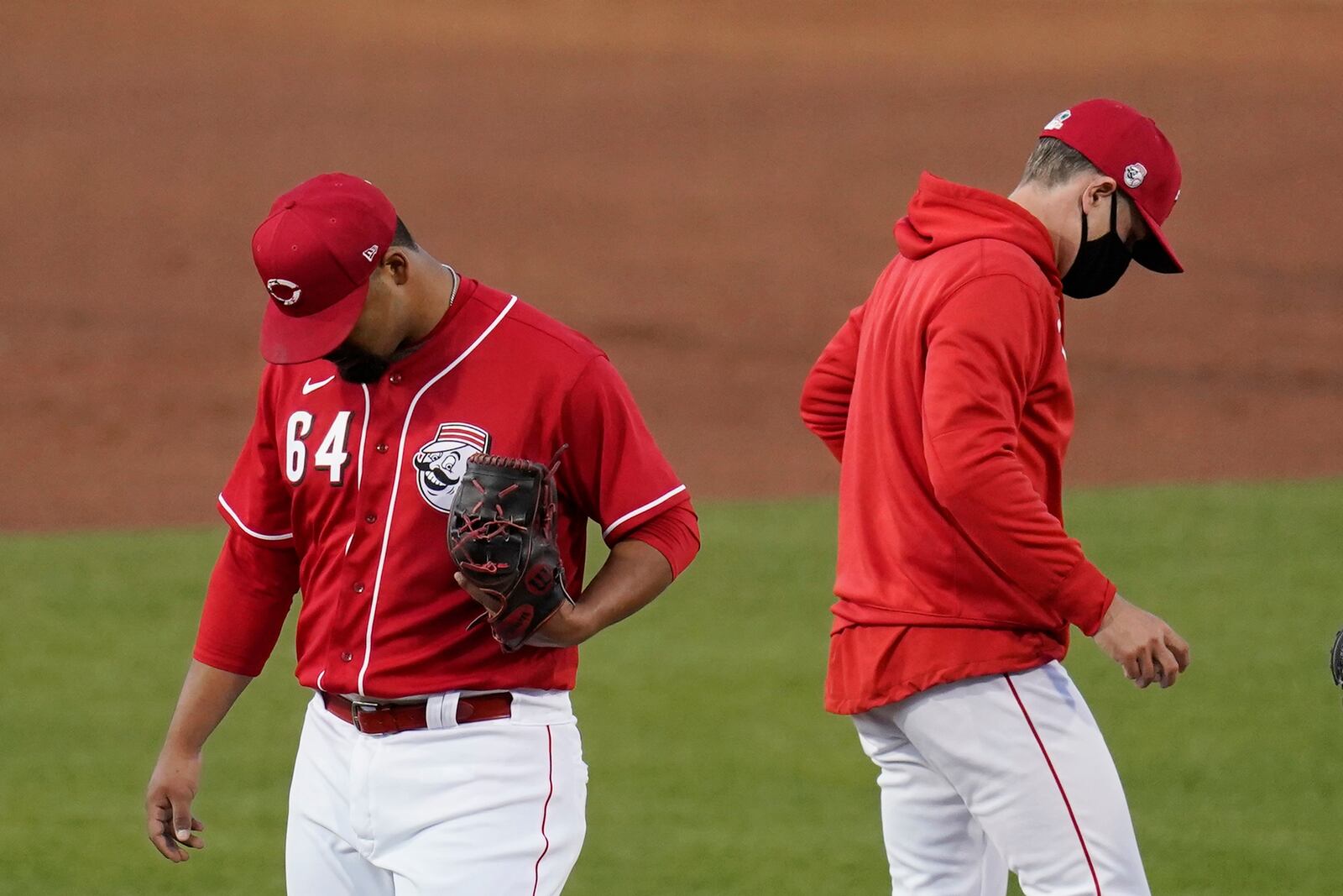 Cincinnati Reds starting pitcher Tony Santillan (64) is taken out by Reds manager David Bell, right, during the second inning of a spring training baseball game against the Texas Rangers Wednesday, March 24, 2021, in Goodyear, Ariz. (AP Photo/Ross D. Franklin)