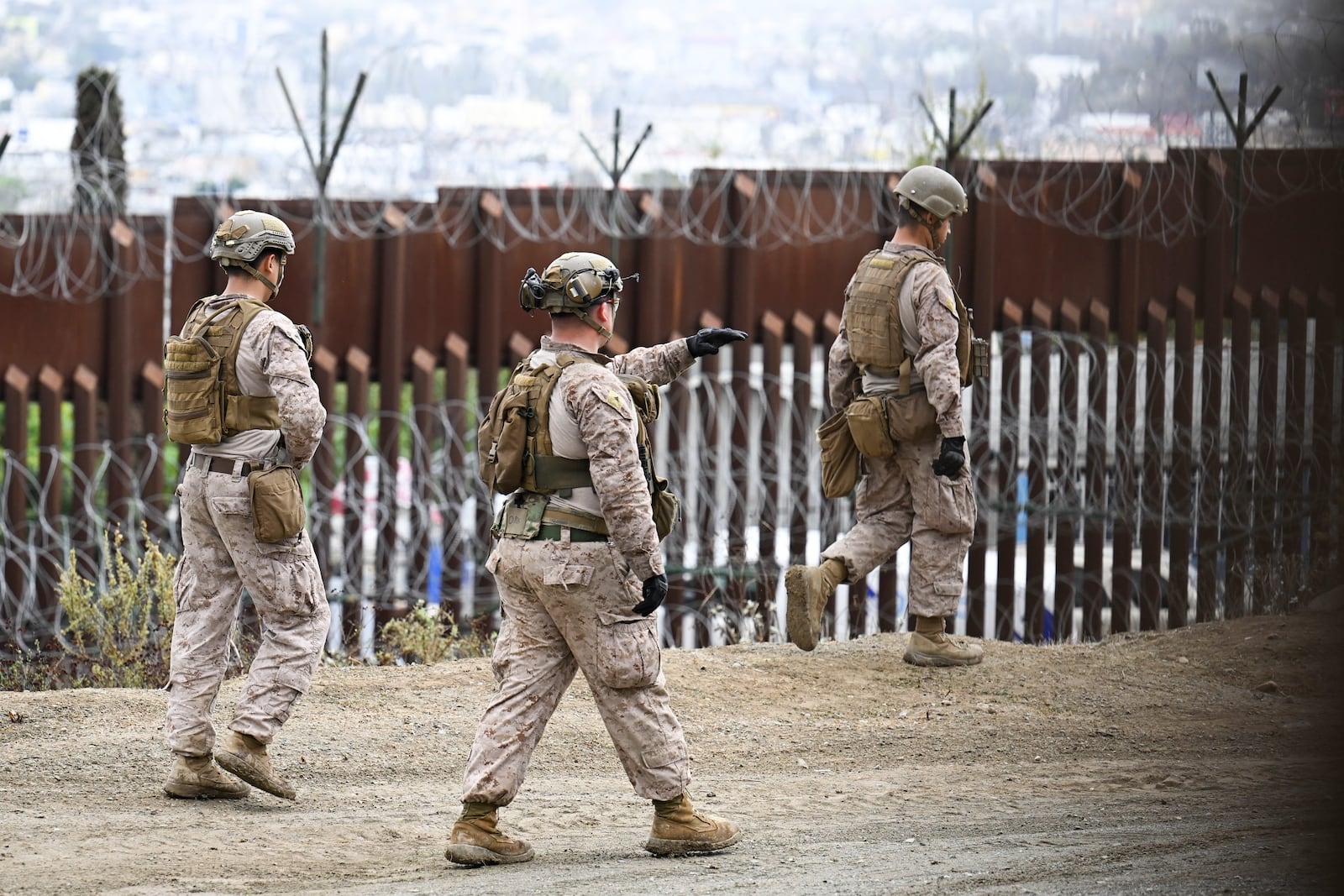 U.S. Marines deploy along the U.S.-Mexico border near the San Ysidro Port of Entry, Friday, Feb. 7, 2025, in San Diego with Tijuana, Mexico in the background. (AP Photo/Denis Poroy)