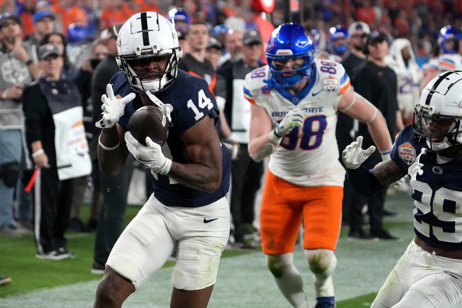 Penn State safety Tyrece Mills (14) intercepts a pass against Boise State during the second half of the Fiesta Bowl College Football Playoff game, Tuesday, Dec. 31, 2024, in Glendale, Ariz. (AP Photo/Rick Scuteri)