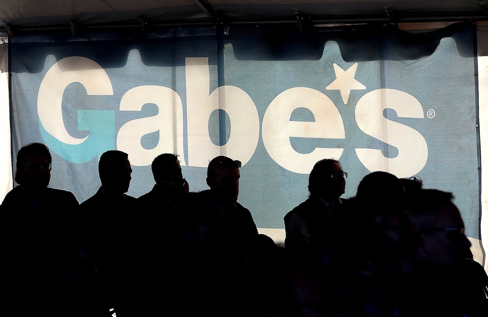 A crowd gathers in the shade of a tent during the groundbreaking ceremony for the new 870,000 square foot Gabe's distribution center at Prime Ohio II industrial park. BILL LACKEY/STAFF