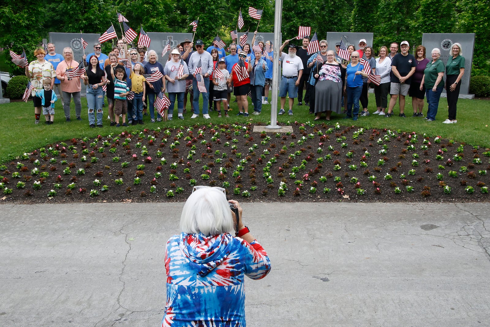 Volunteers were busy Saturday morning, May 18, 2024 placing over 3,000 American flags on the graves of service men and women interred in Ferncliff Cemetery for Memorial Day. Over 40 volunteers, including a large group from Werner Enterprises, placed flags on the central GAR (Civil War) mound, WWI section, WWII section and the Annex with more recent graves. The event was organized by Ferncliff Cemetery and Arboretum. BILL LACKEY/STAFF