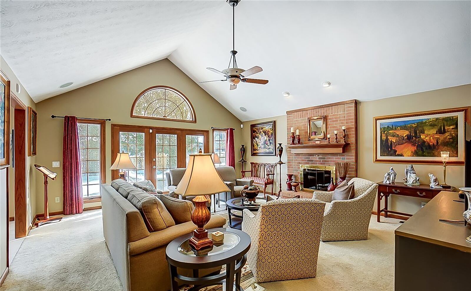 The family room has vaulted ceilings with recessed lighting, a gas fireplace and doors opening to the patio.