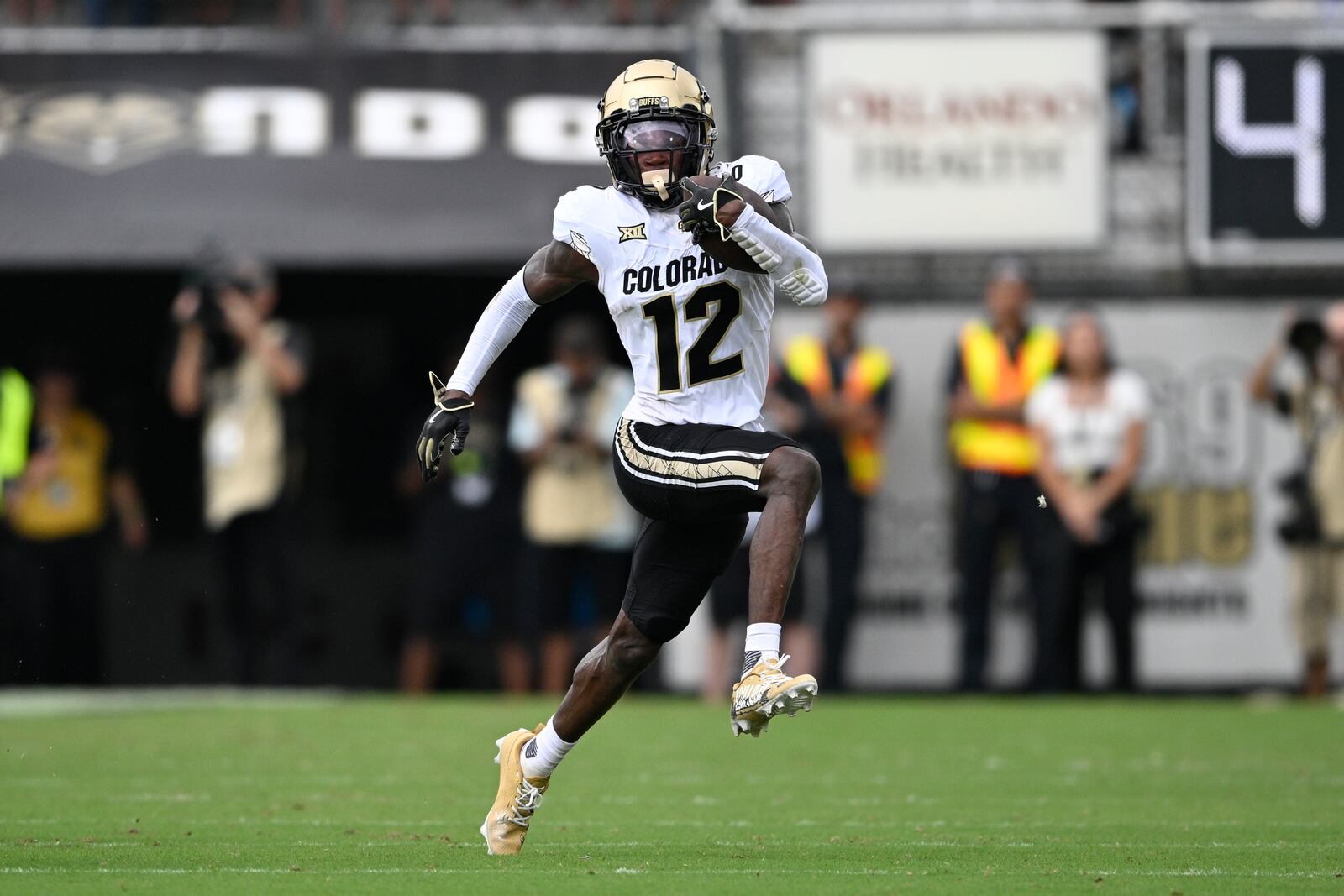 FILE - Colorado wide receiver Travis Hunter (12) runs after catching a pass during the first half of an NCAA college football game against Central Florida, Saturday, Sept. 28, 2024, in Orlando, Fla. (AP Photo/Phelan M. Ebenhack, File)