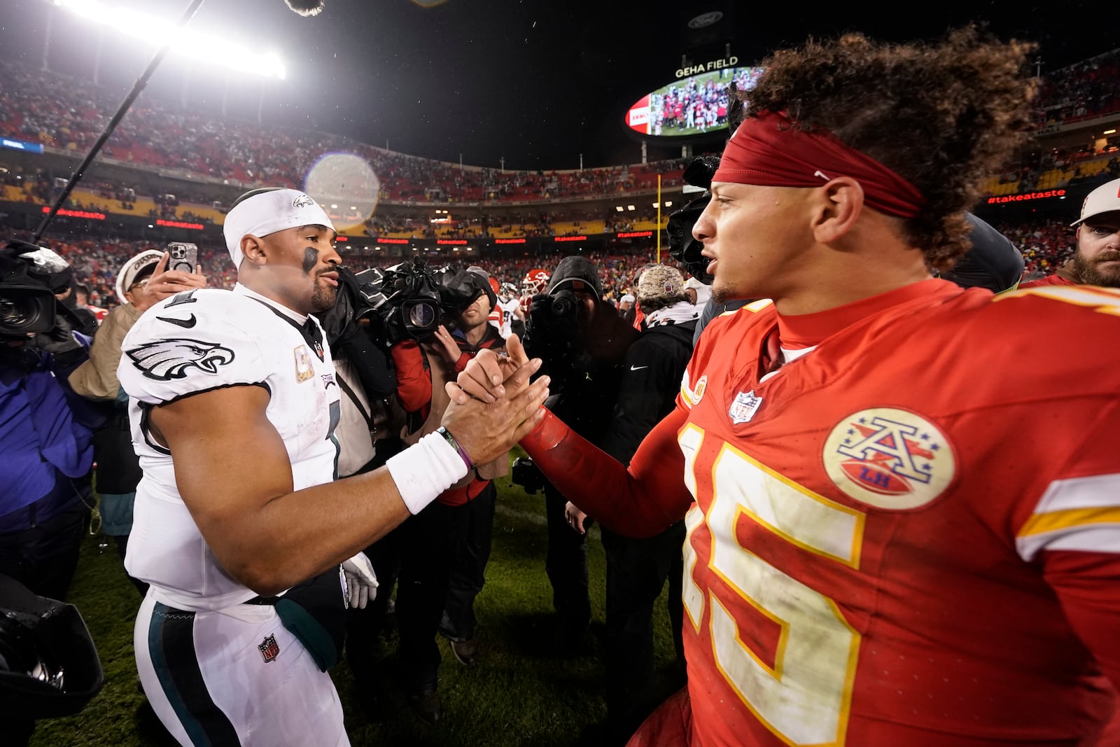 FILE- Philadelphia Eagles quarterback Jalen Hurts, left, and Kansas City Chiefs quarterback Patrick Mahomes (15) shake hands following an NFL football game on Monday, Nov. 20, 2023, in Kansas City, Mo. (AP Photo/Charlie Riedel, File)