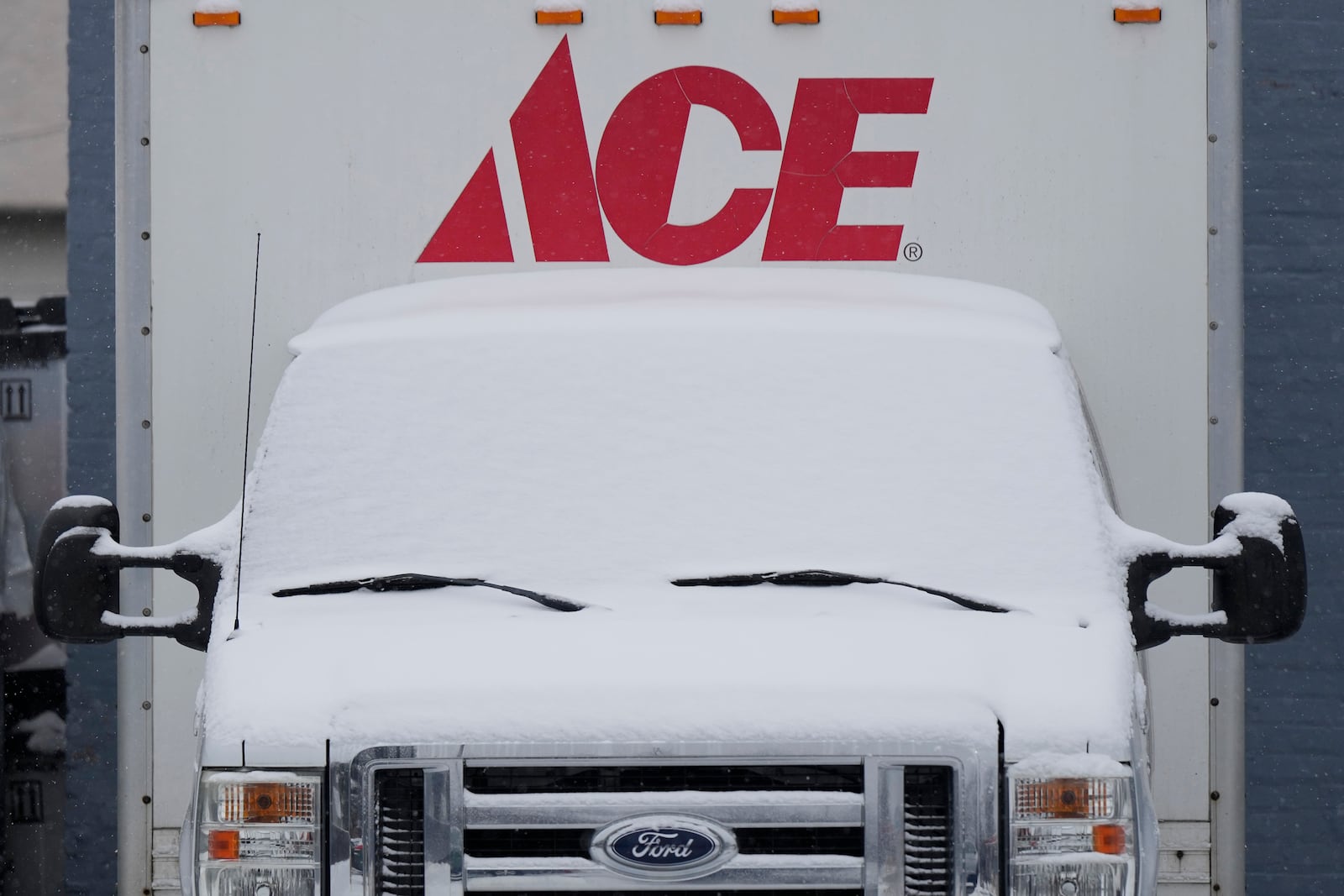 Snow covered a delivery truck in a parking lot of a hardware store during a snowy day in Glenview, Ill., Friday, Jan. 10, 2025. (AP Photo/Nam Y. Huh)