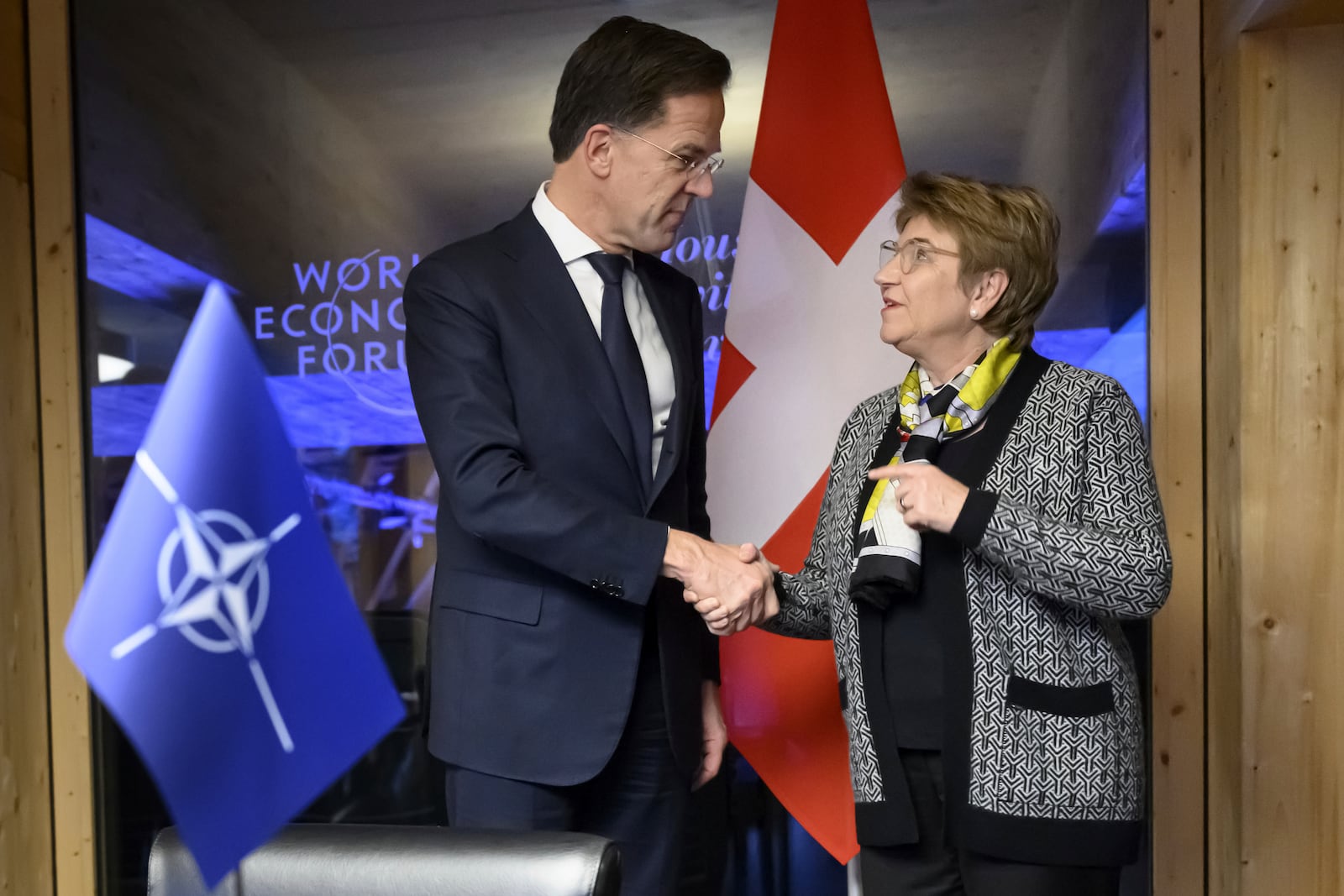 Switzerland's Defense Minister Federal Councillor Viola Amherd, right, shakes hands with NATO Secretary General Mark Rutte, left, prior to a bilateral meeting on the sideline of the Annual Meeting of the World Economic Forum in Davos, Switzerland, Wednesday, Jan. 22, 2025. (Laurent Gillieron/Keystone via AP)